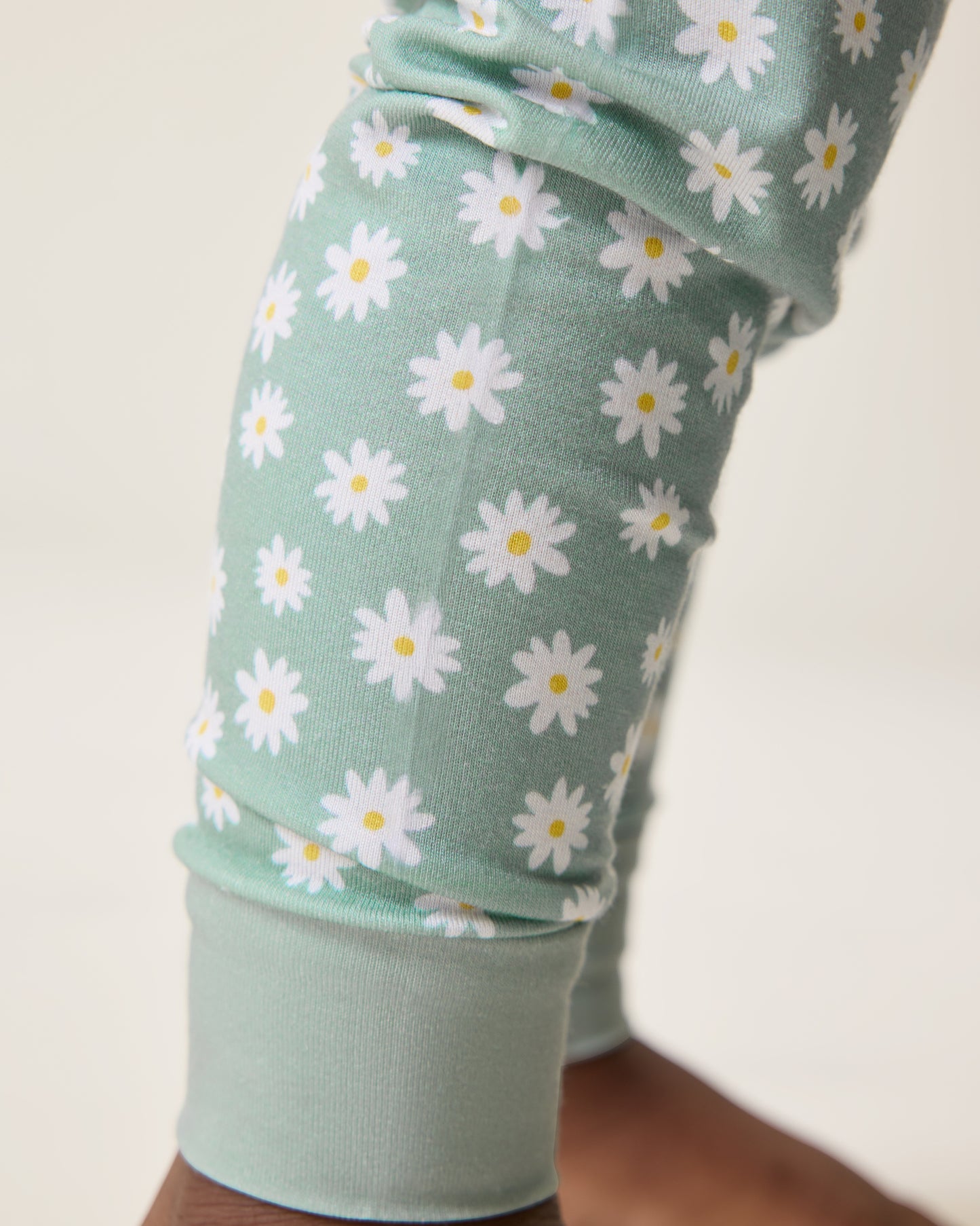 Close up of Baby wearing the Bamboo Baby Two-Piece Pajama Set in Sage Daisies print