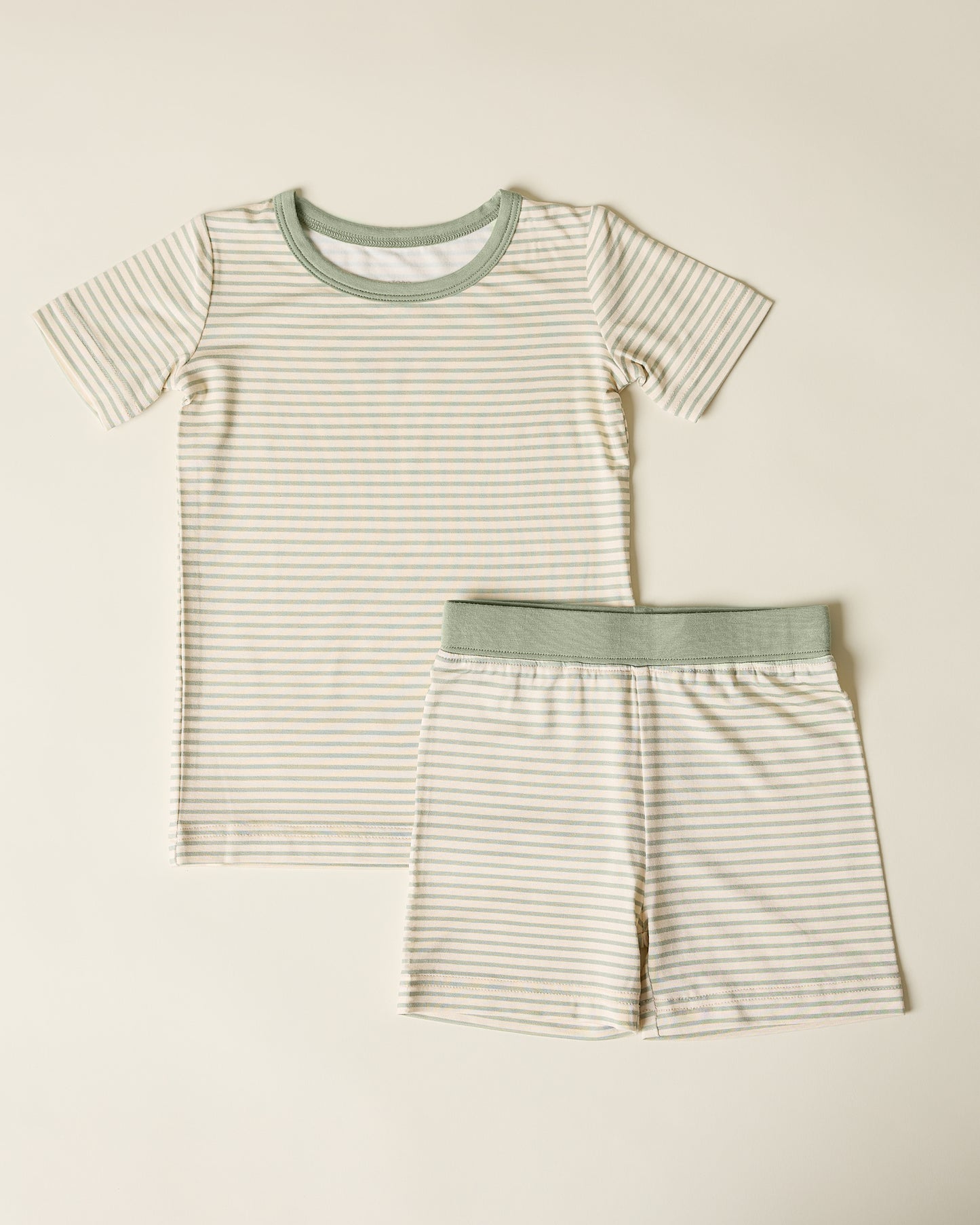 Children's Bamboo Short Sleeve & Shorts Set in sage green stripe on a beige background