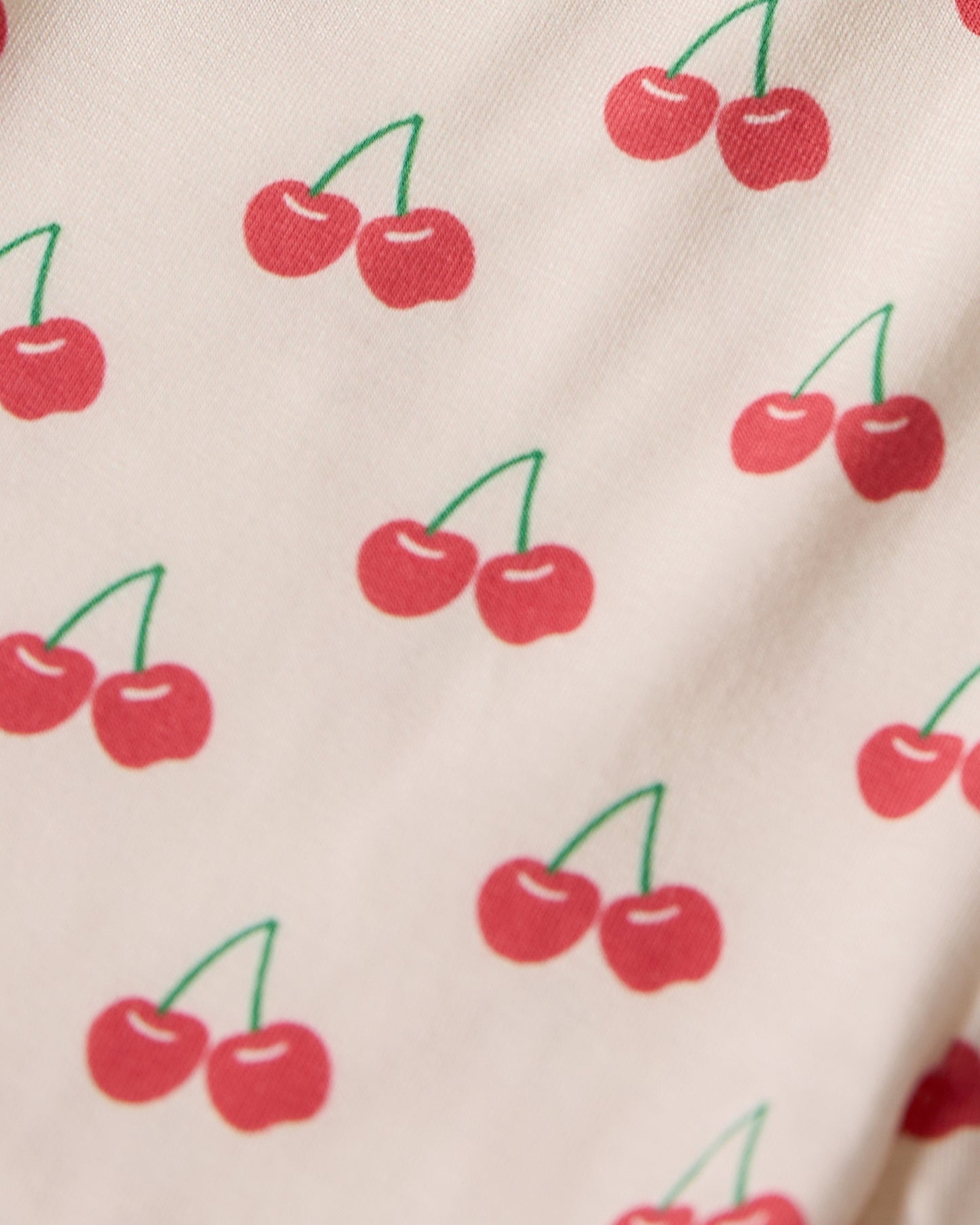 Pattern of red cherries on a beige background