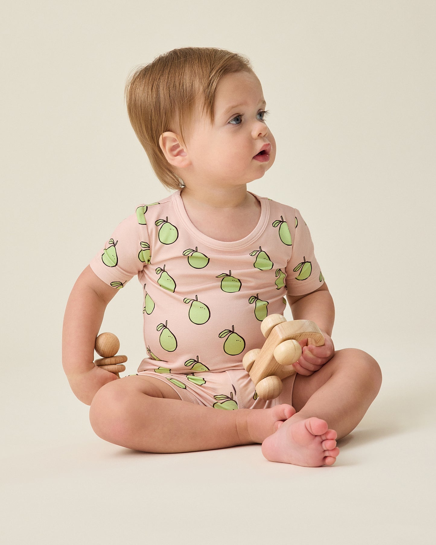 Baby wearing the Bamboo Short Sleeve & Shorts Set in pink pomelo @model_info:Noa is wearing 6-12 months.
