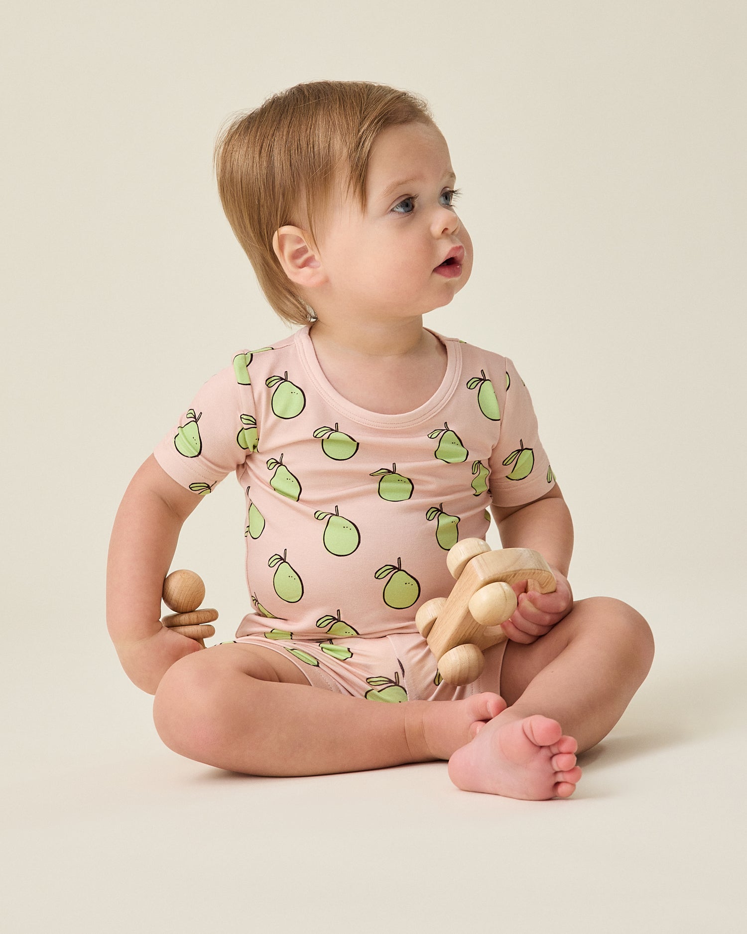 Baby wearing the Bamboo Short Sleeve & Shorts Set in pink pomelo @model_info:Noa is wearing 6-12 months.