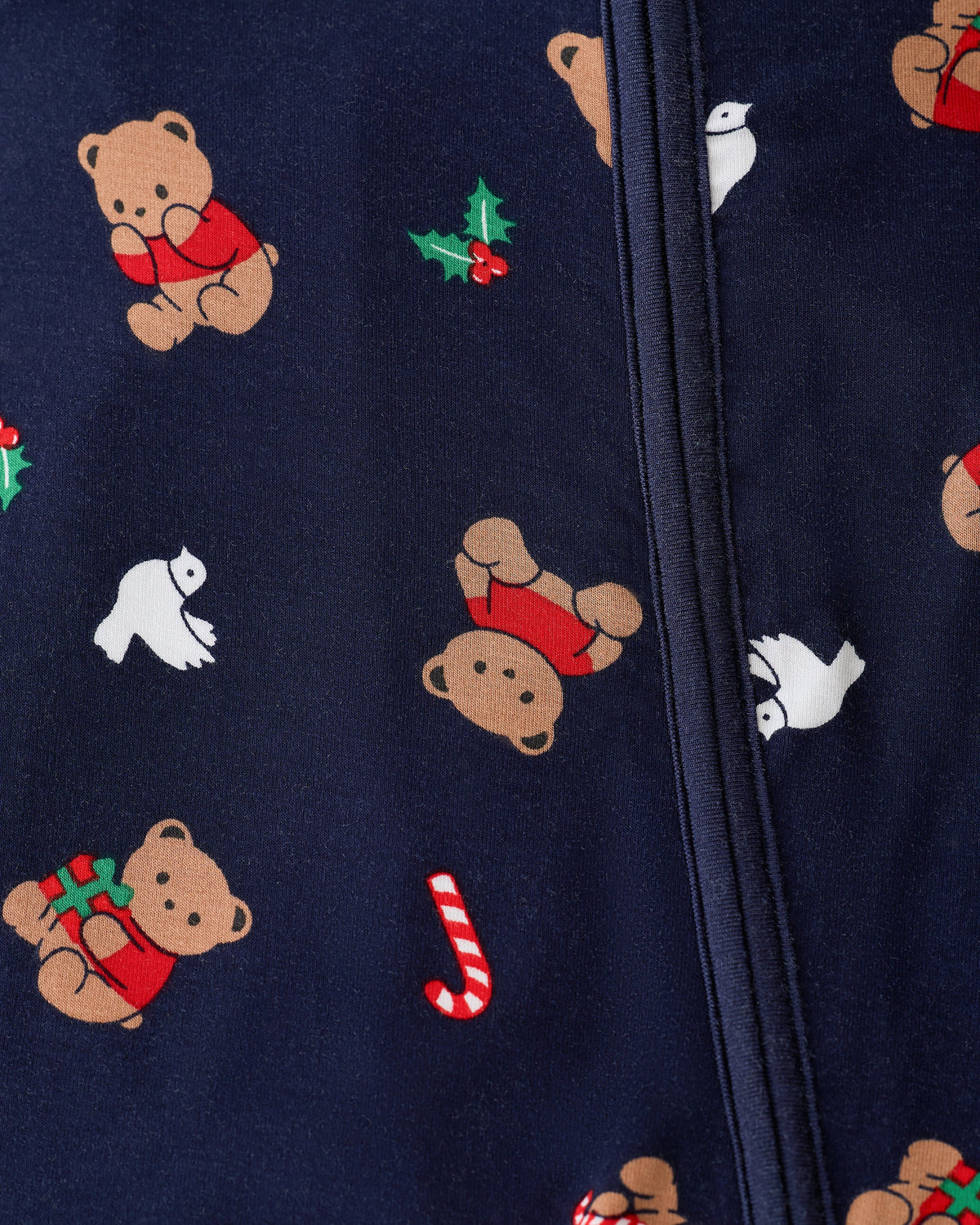Close up of zipper and pattern detail on Bamboo Baby Pajama in Bearing Gifts on an off white background.