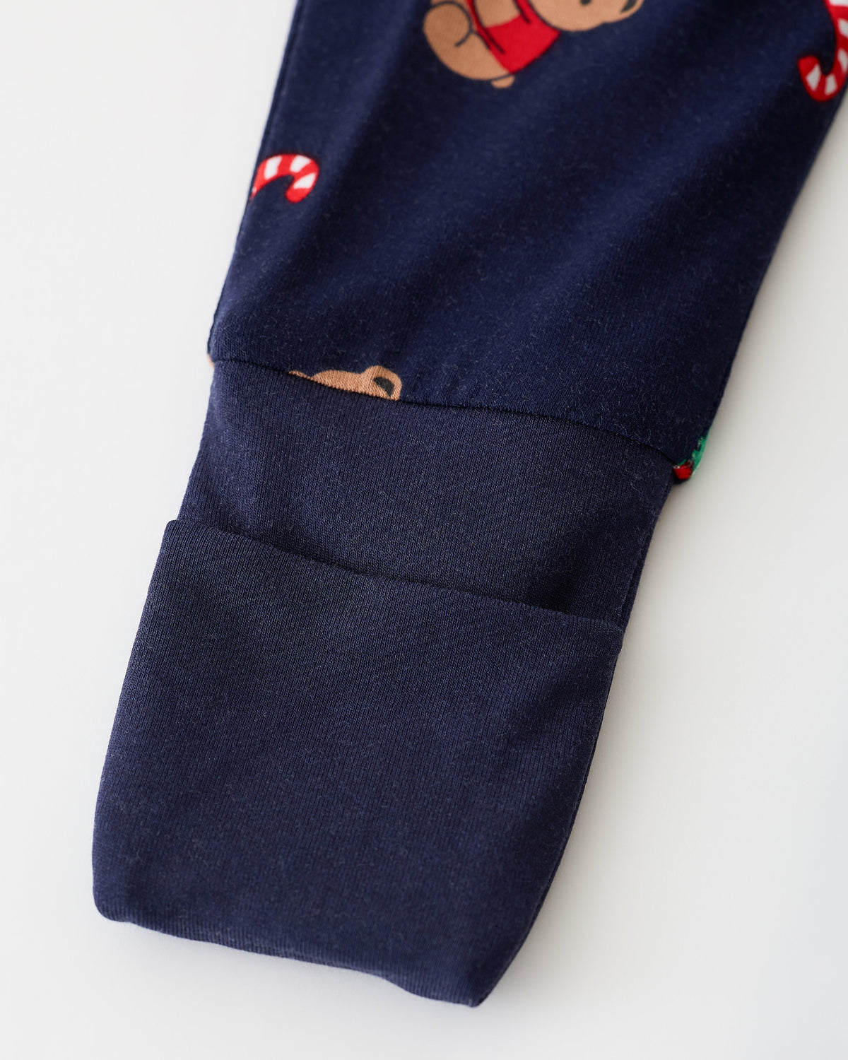 Close up of sleeve detail on Bamboo Baby Pajama in Bearing Gifts on an off white background.