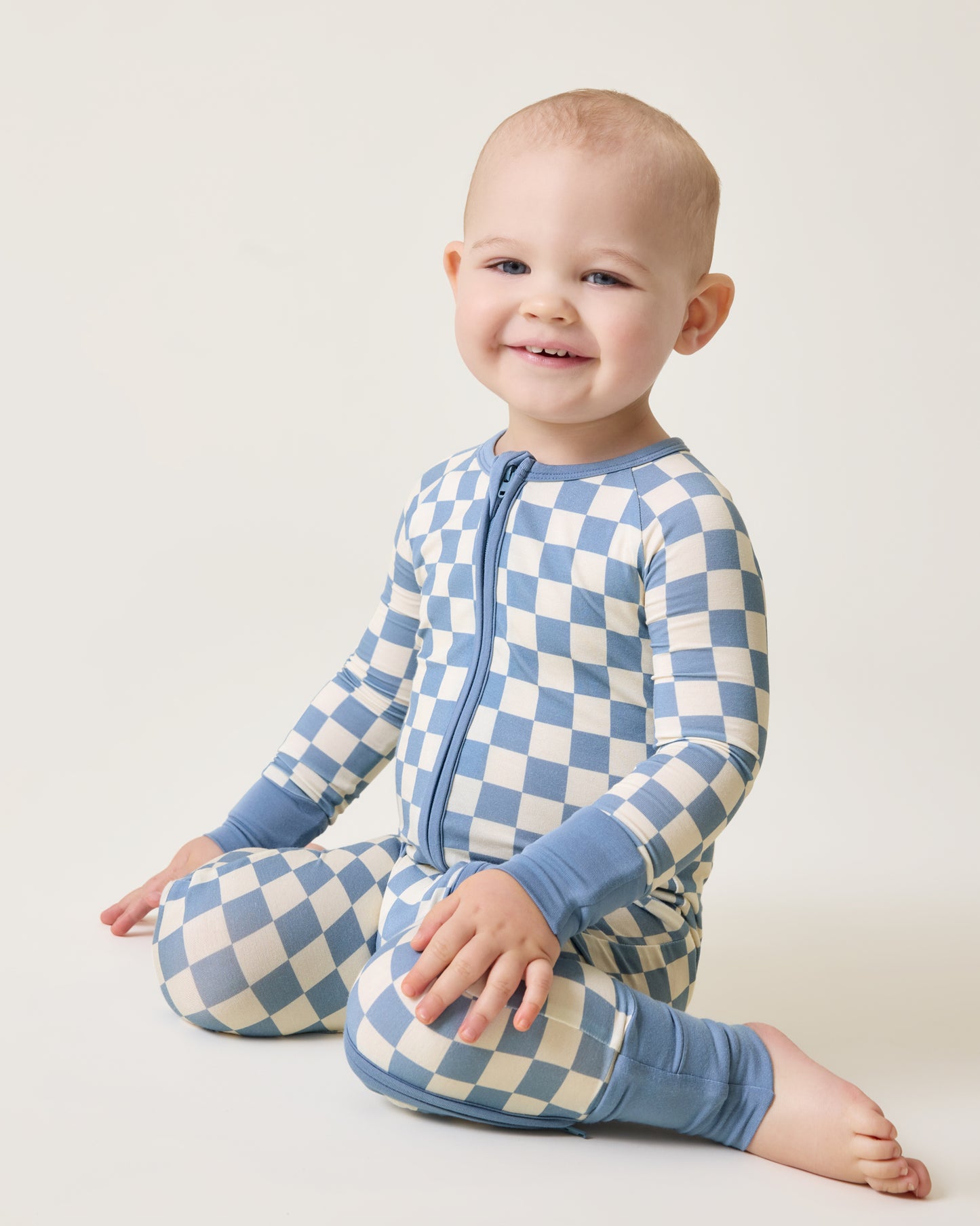 Baby wearing the Bamboo Baby Pajama in Blue Checker print@model_info:Clark is wearing 18-24 months.