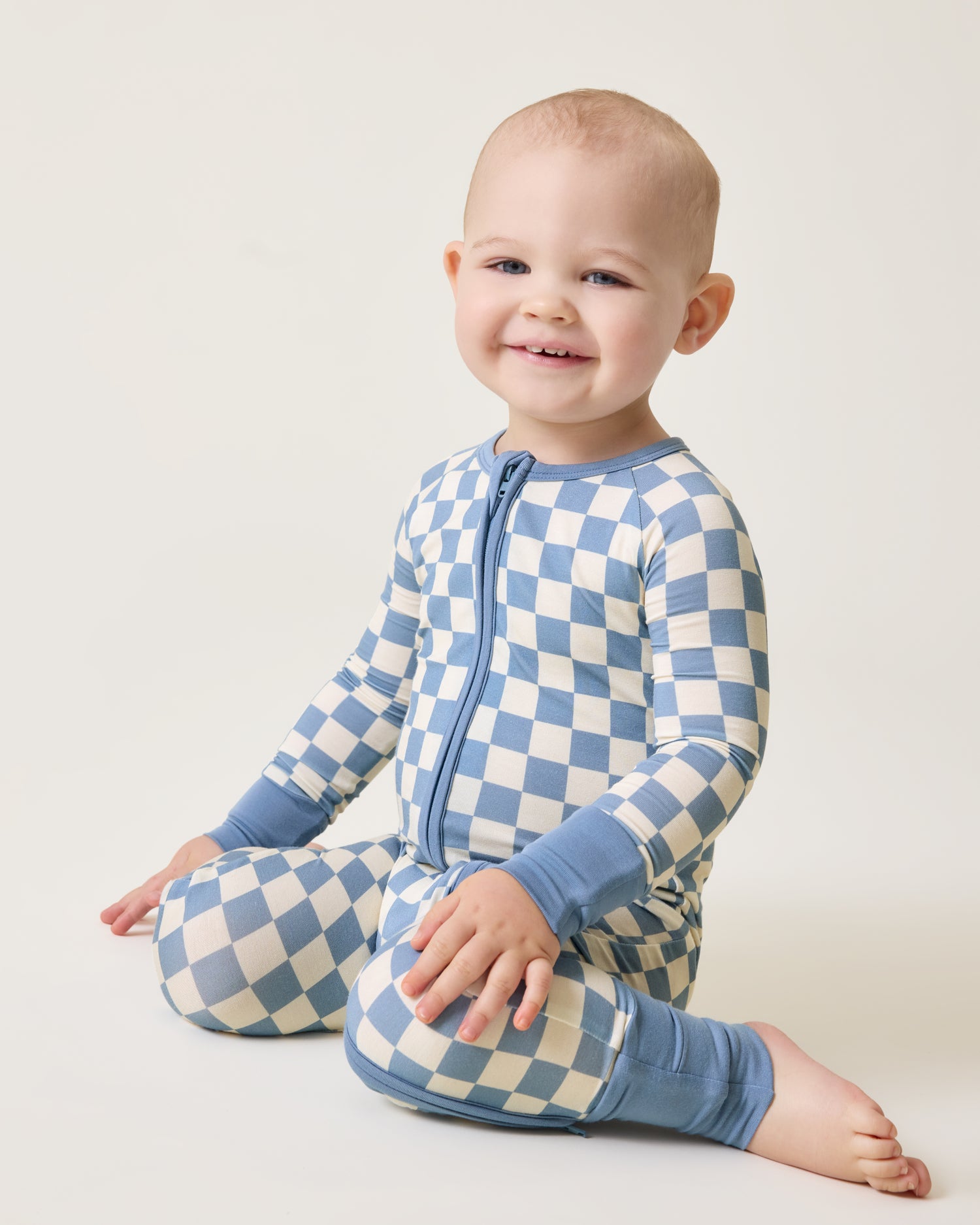 Baby wearing the Bamboo Baby Pajama in Blue Checker print@model_info:Clark is wearing 18-24 months.