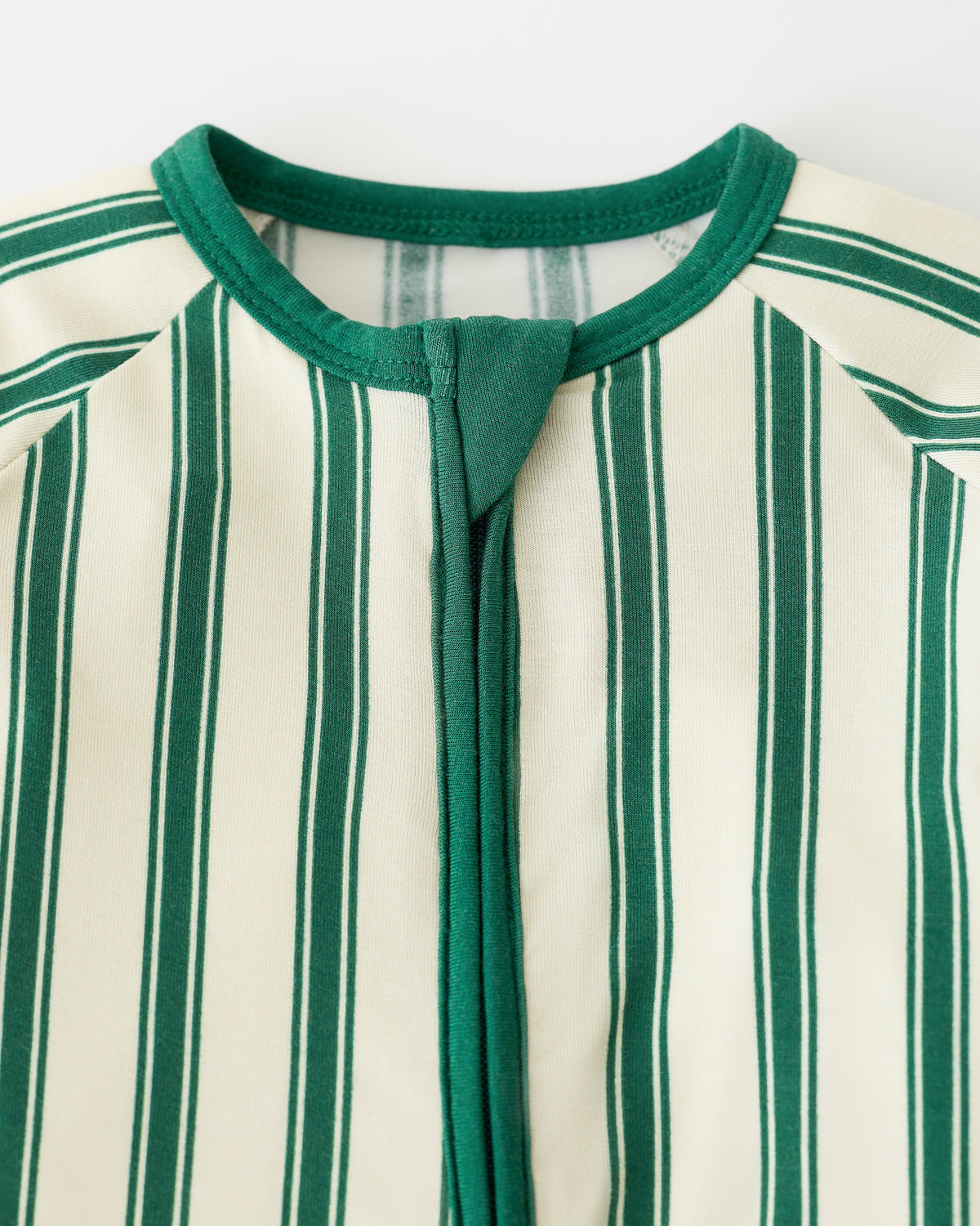 Close up of collar detail on Bamboo Baby Pajama in Green Candy Stripe on an off white background.