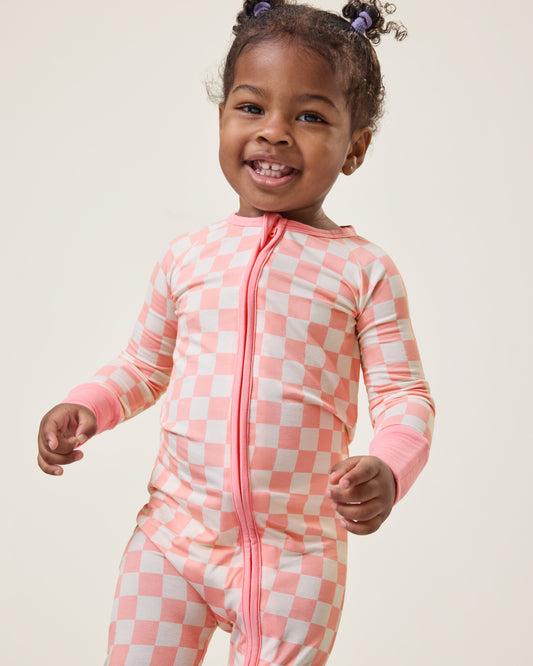 Baby wearing the Bamboo Baby Pajama in Pink Checker print@model_info:Harper is wearing 18-24 months.
