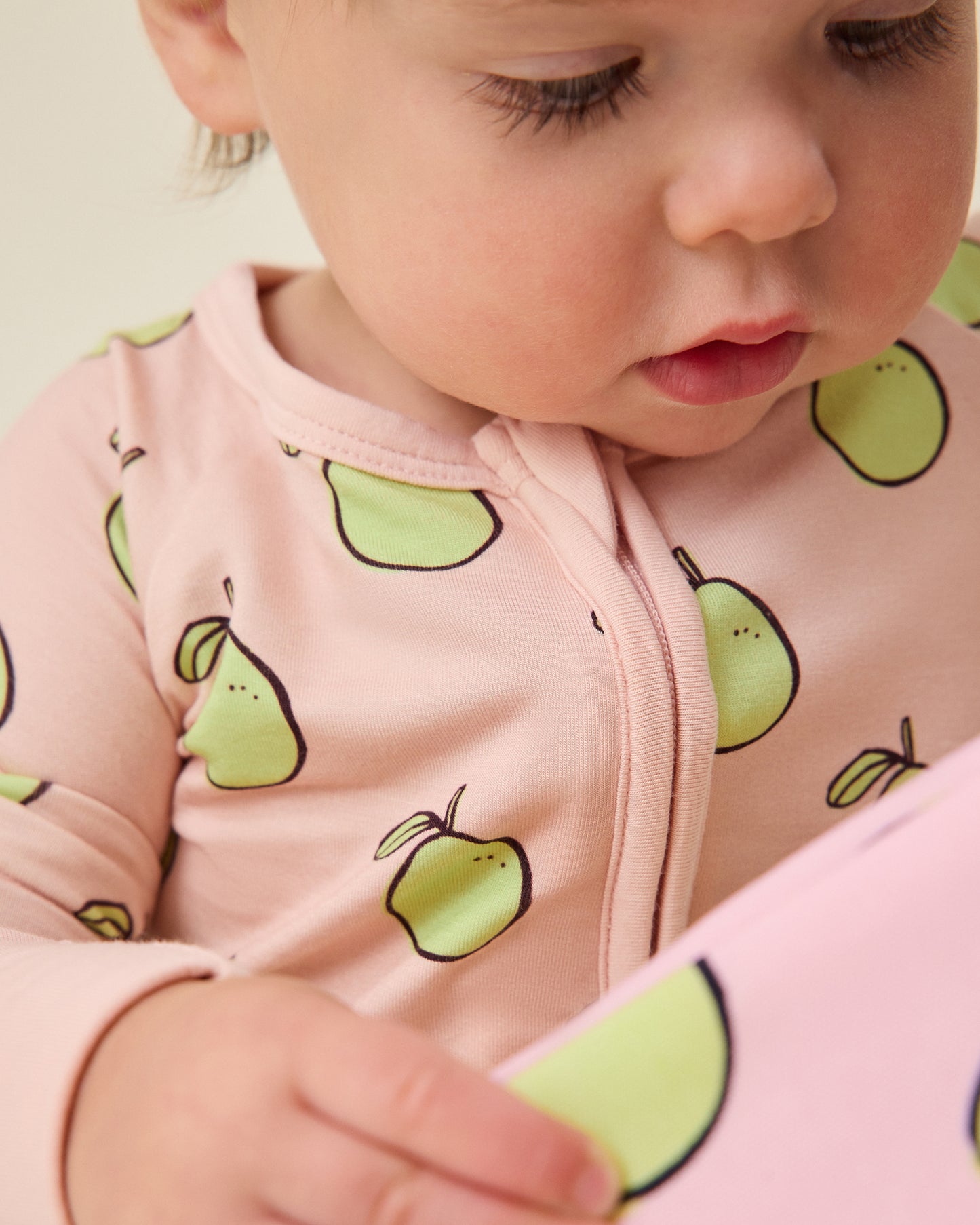 Baby wearing the Bamboo Baby Pajama in pink pomelo