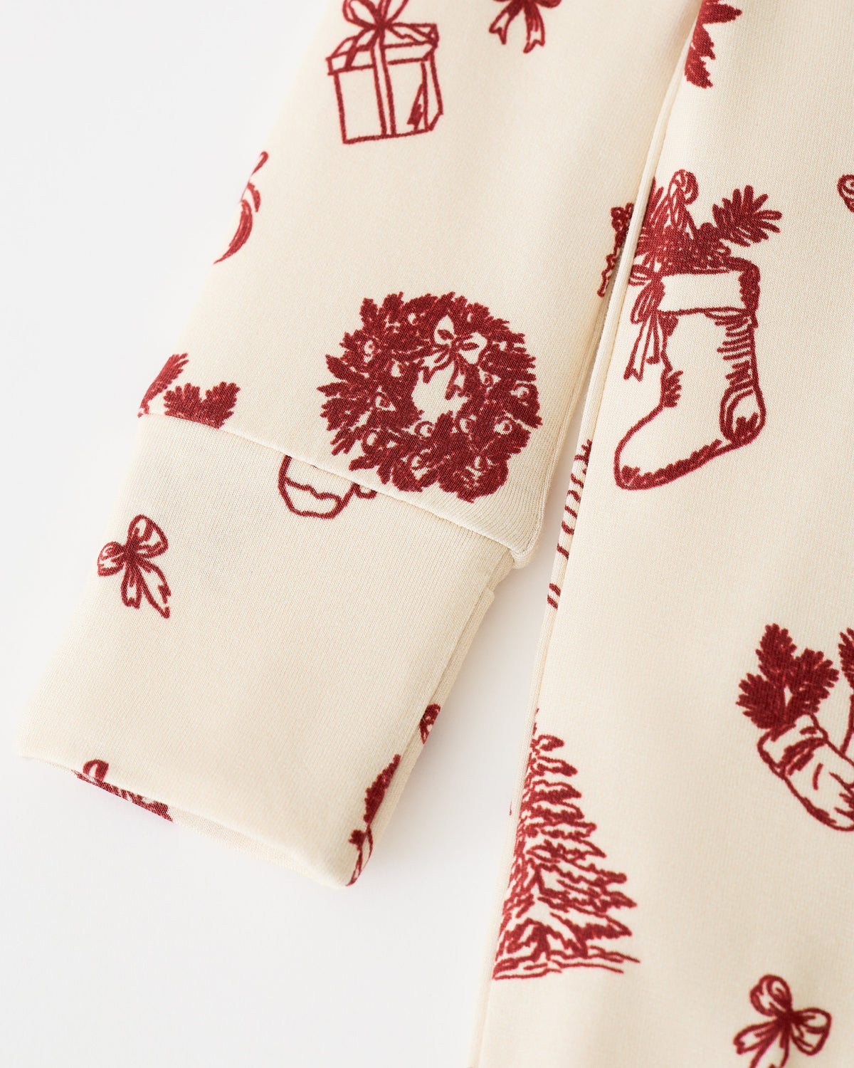 Close up of sleeve detail on Bamboo Baby Pajama in Cozy Day on an off white background.