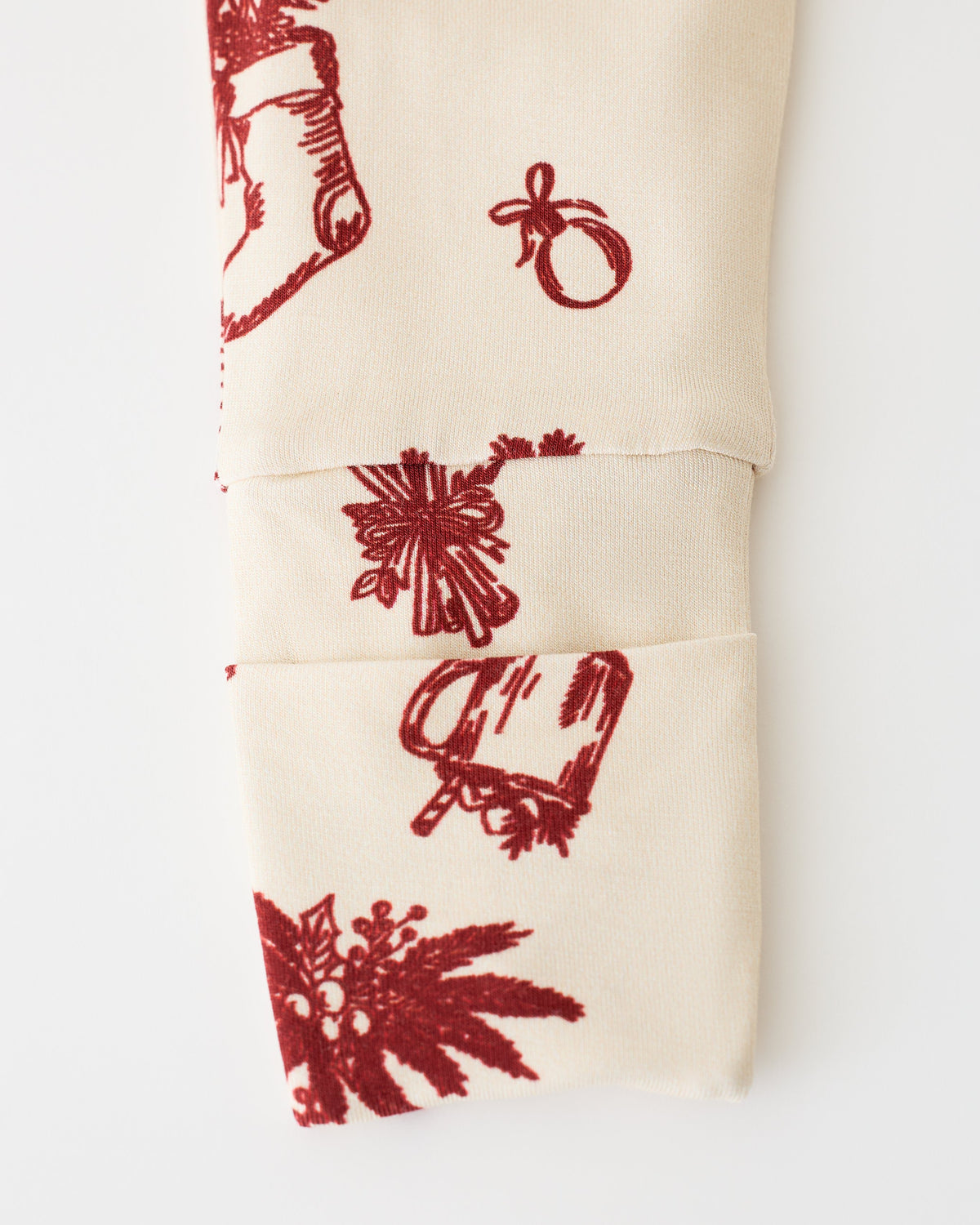 Close up of pant detail on Bamboo Baby Pajama in Cozy Day pattern, on an off white background.