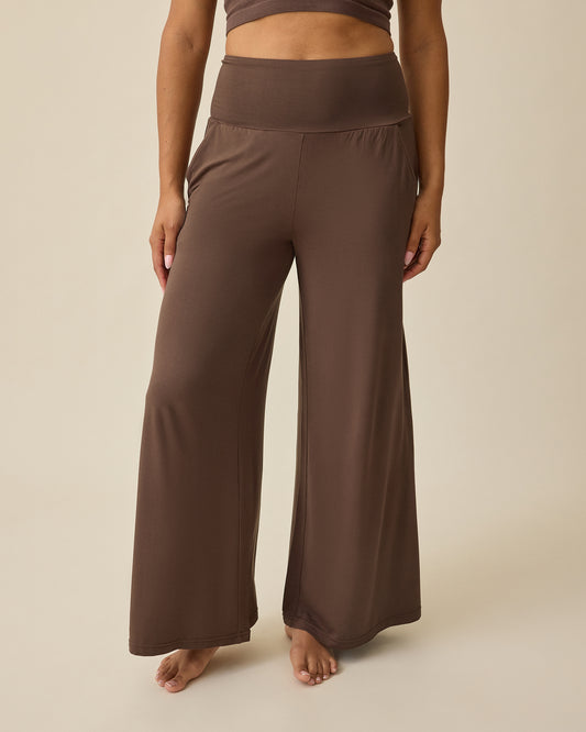 Bamboo Wide Leg Maternity & Postpartum Lounge Pant in Chocolate on a beige background @model_info:Mei is 5'8" and wearing a Small.