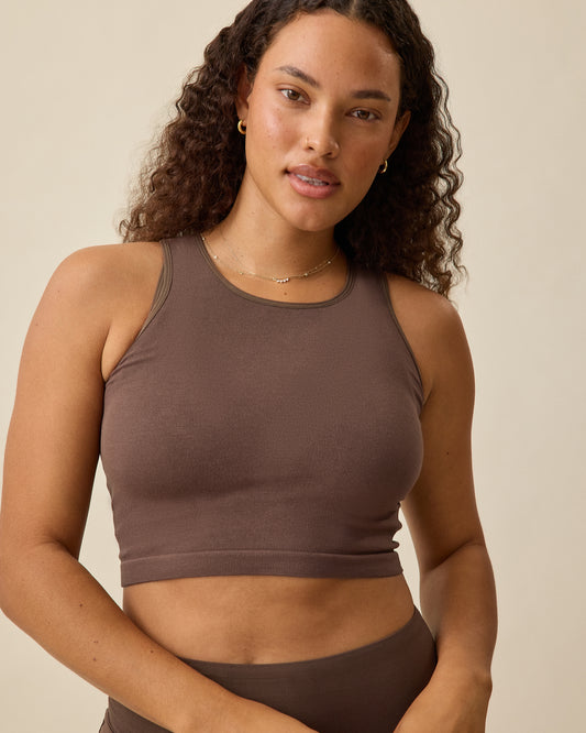 Model wearing Sublime® Bamboo Maternity & Nursing Longline Bra Top in Chocolate, displaying inner shelf bra underneath, on a beige background