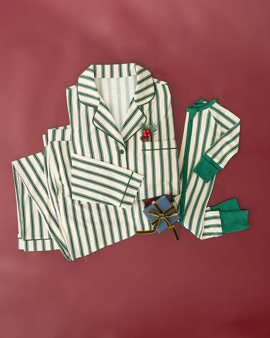 Bamboo Baby Pajama in Green Candy Stripe and Clea Bamboo Long Sleeve Pajama Set in Green Candy Stripe with a sprig of fir tree and little gift box, on a burgundy background.