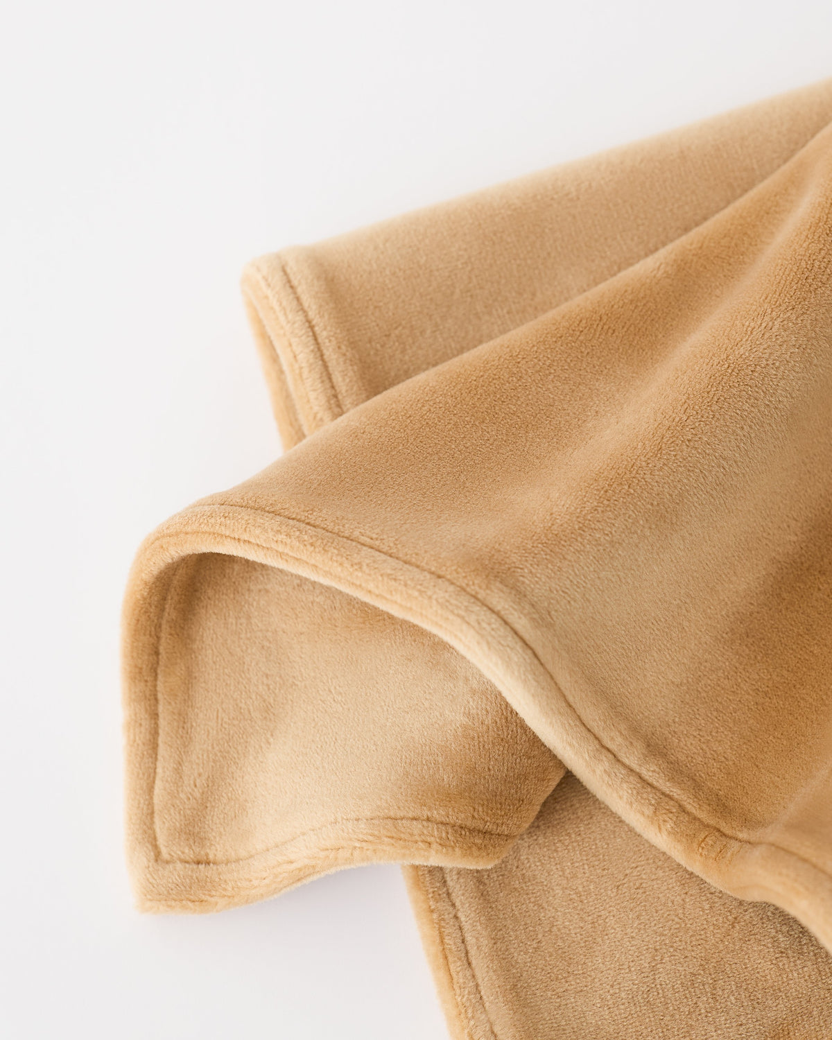 Close up of blanket detail on Brown Bear Cuddle Buddy Lovey, on an off white background.