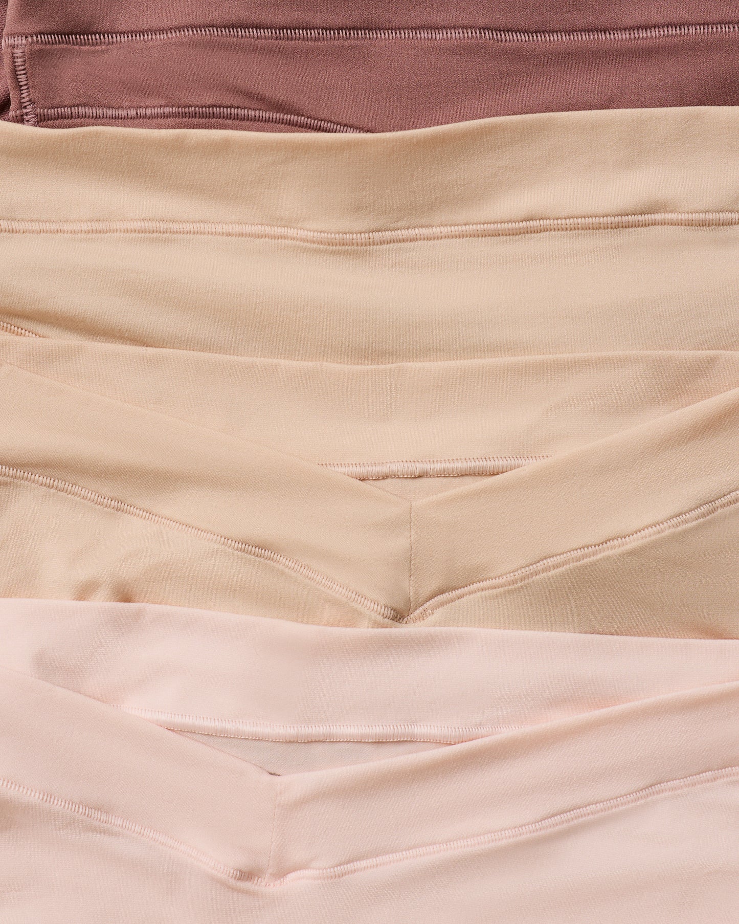 Close-up of fabric in brown, beige, and pink colors.
