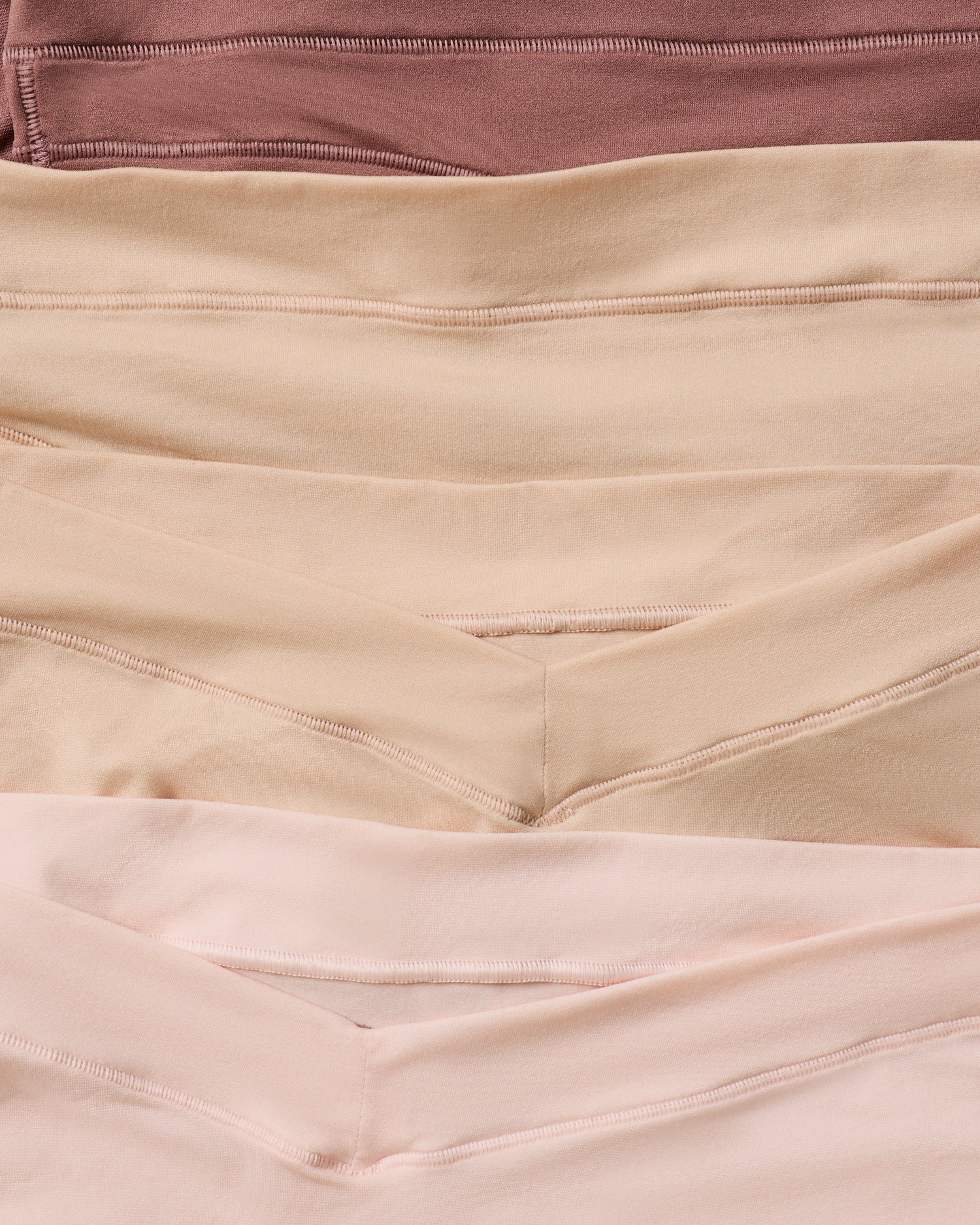 Close-up of fabric in brown, beige, and pink colors.