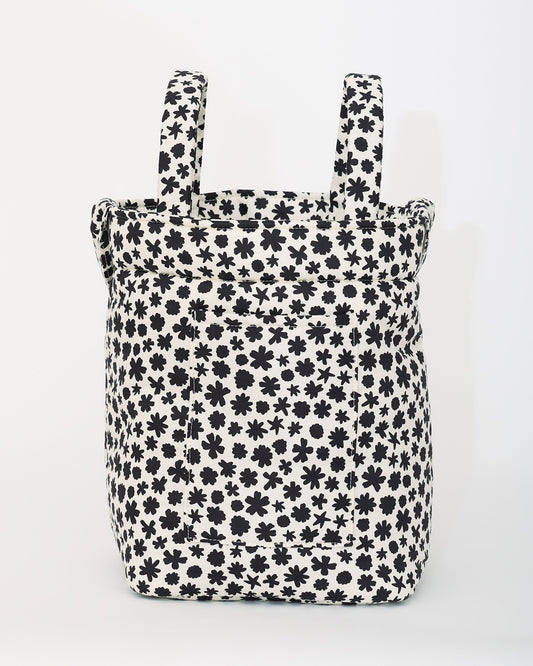 Stroller Party™ Bucket Bag in Cream Chamomiles is sitting upright, on a beige background.