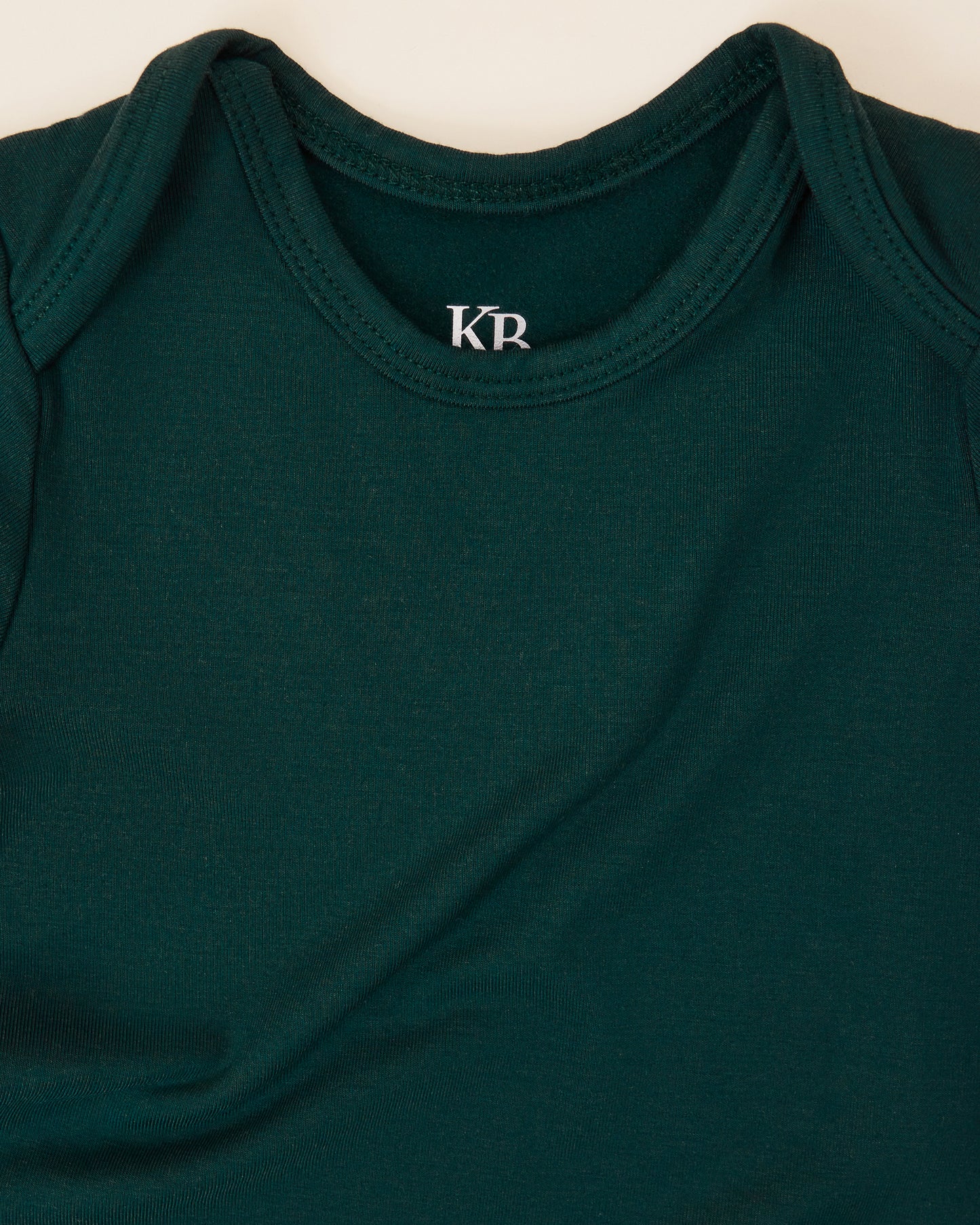 Close up of the neckline on the Cozy Bamboo Baby Gown & Hat in Evergreen 