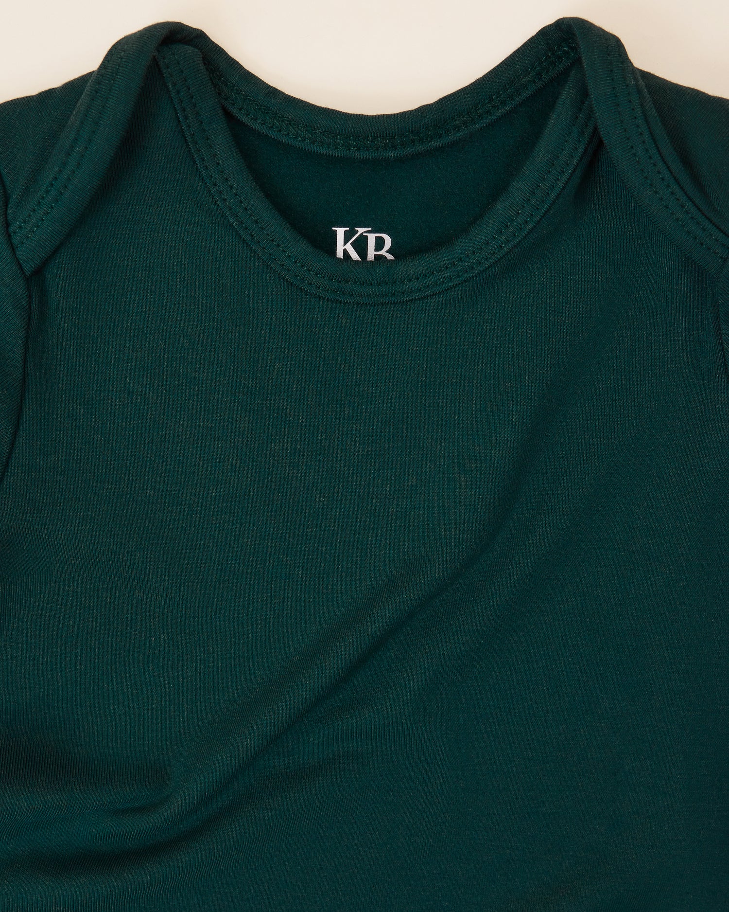 Close up of the neckline on the Cozy Bamboo Baby Gown & Hat in Evergreen 