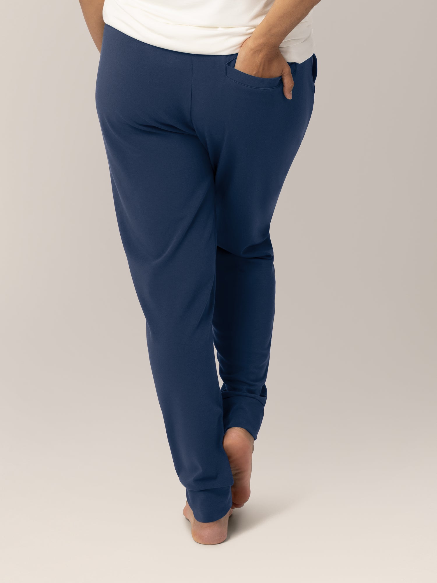 Cropped in back view of model wearing the Bamboo Maternity & Postpartum Jogger in Navy, with a hand in the back pocket.