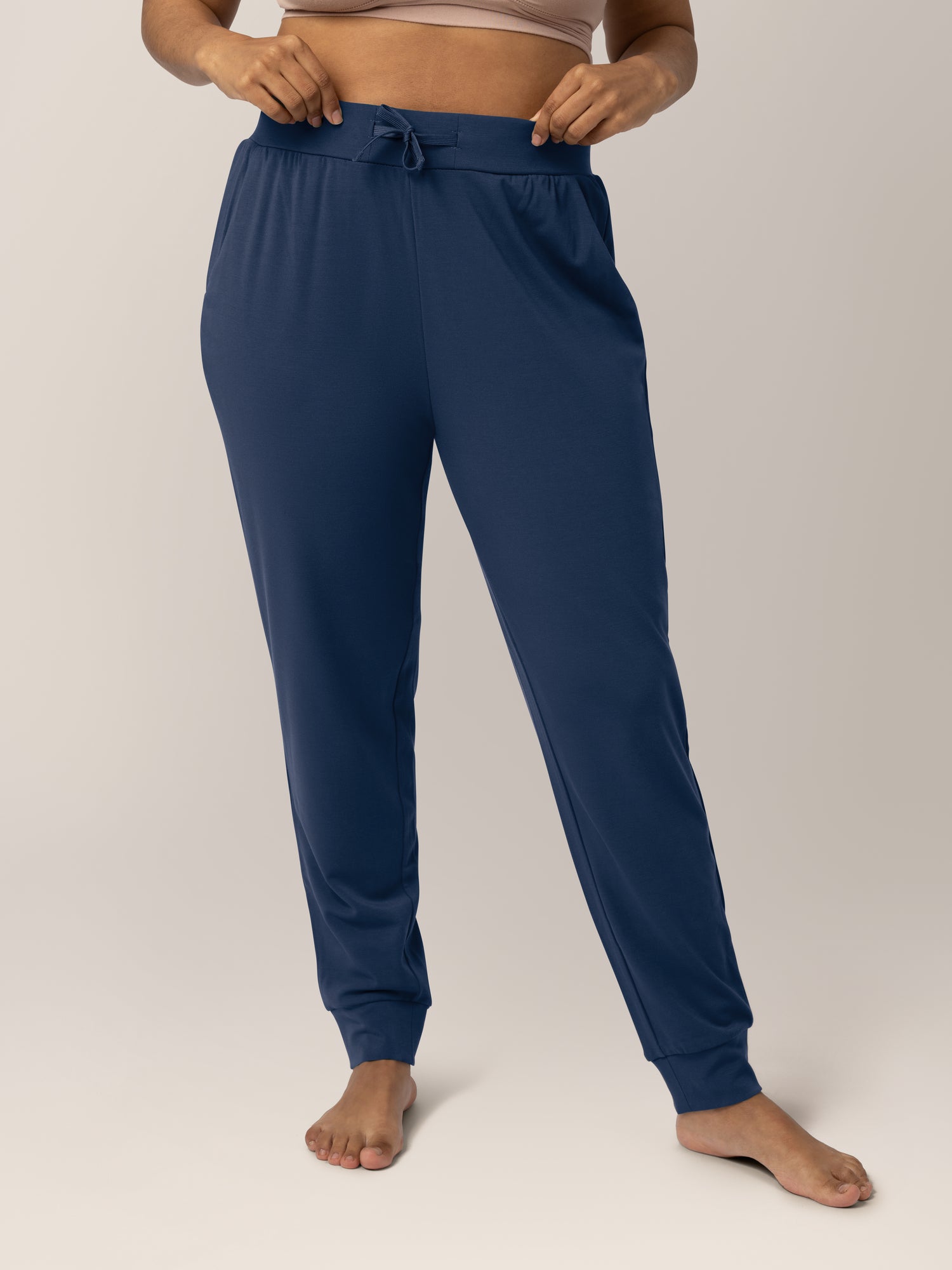 Cropped in front view of model wearing the Bamboo Maternity & Postpartum Jogger in Navy,