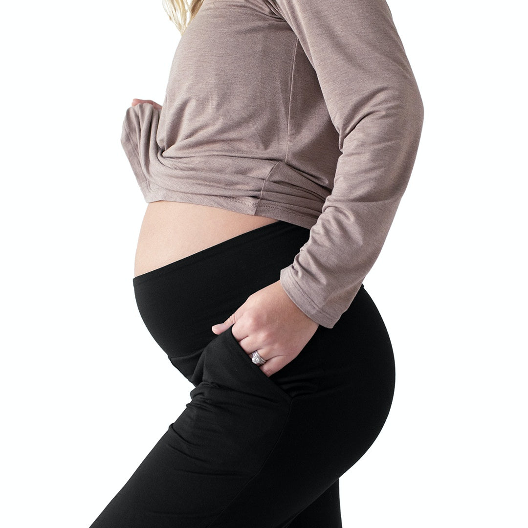 Close up of a pregnant model with her hand in her pocket wearing the Bamboo Maternity & Postpartum Lounge Pant in Black