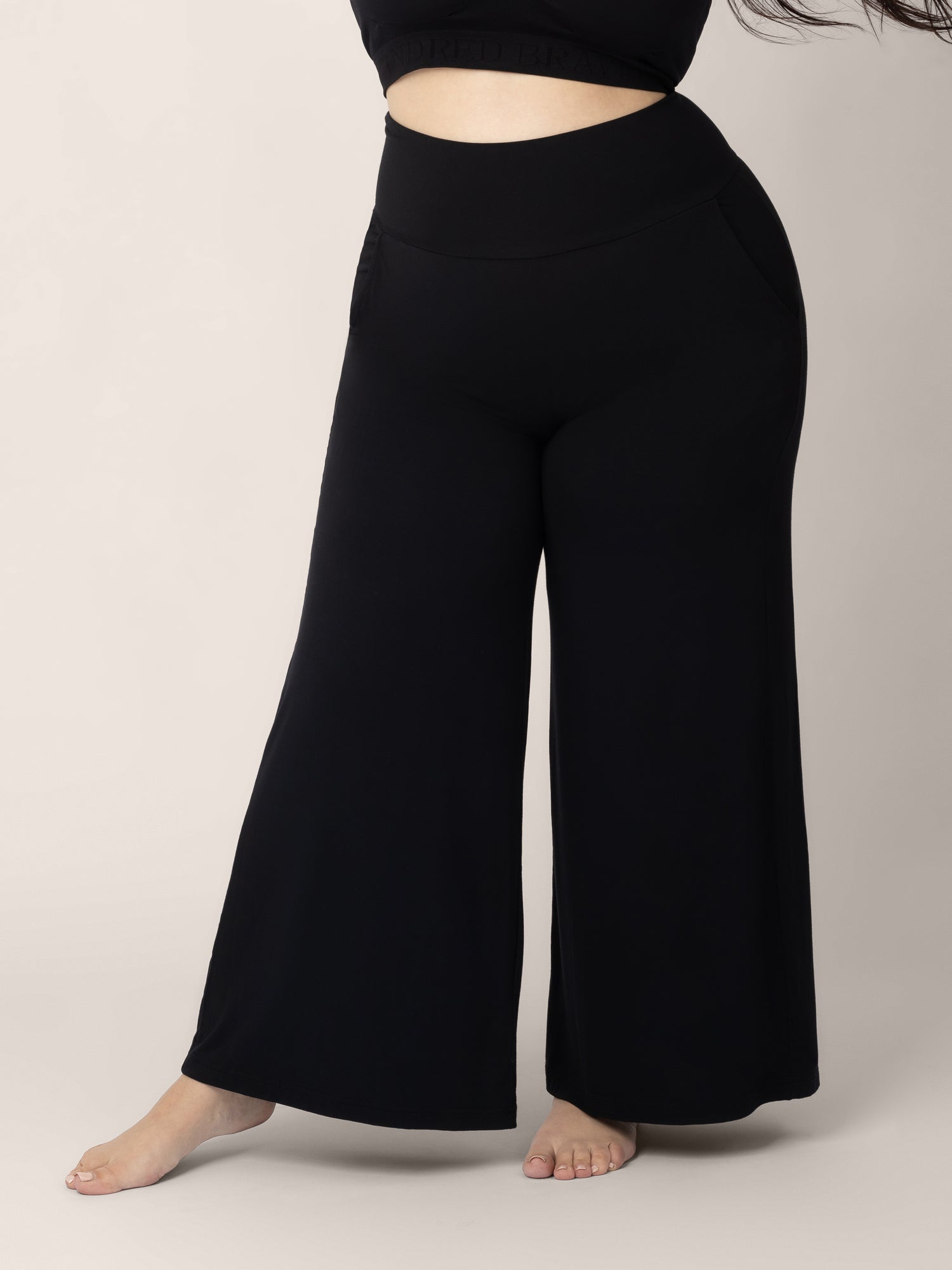 Bottom half of a model wearing the Bamboo Wide Leg Maternity & Postpartum Lounge Pant in black. @model_info:Rachel is 5'6" and wearing a Large.