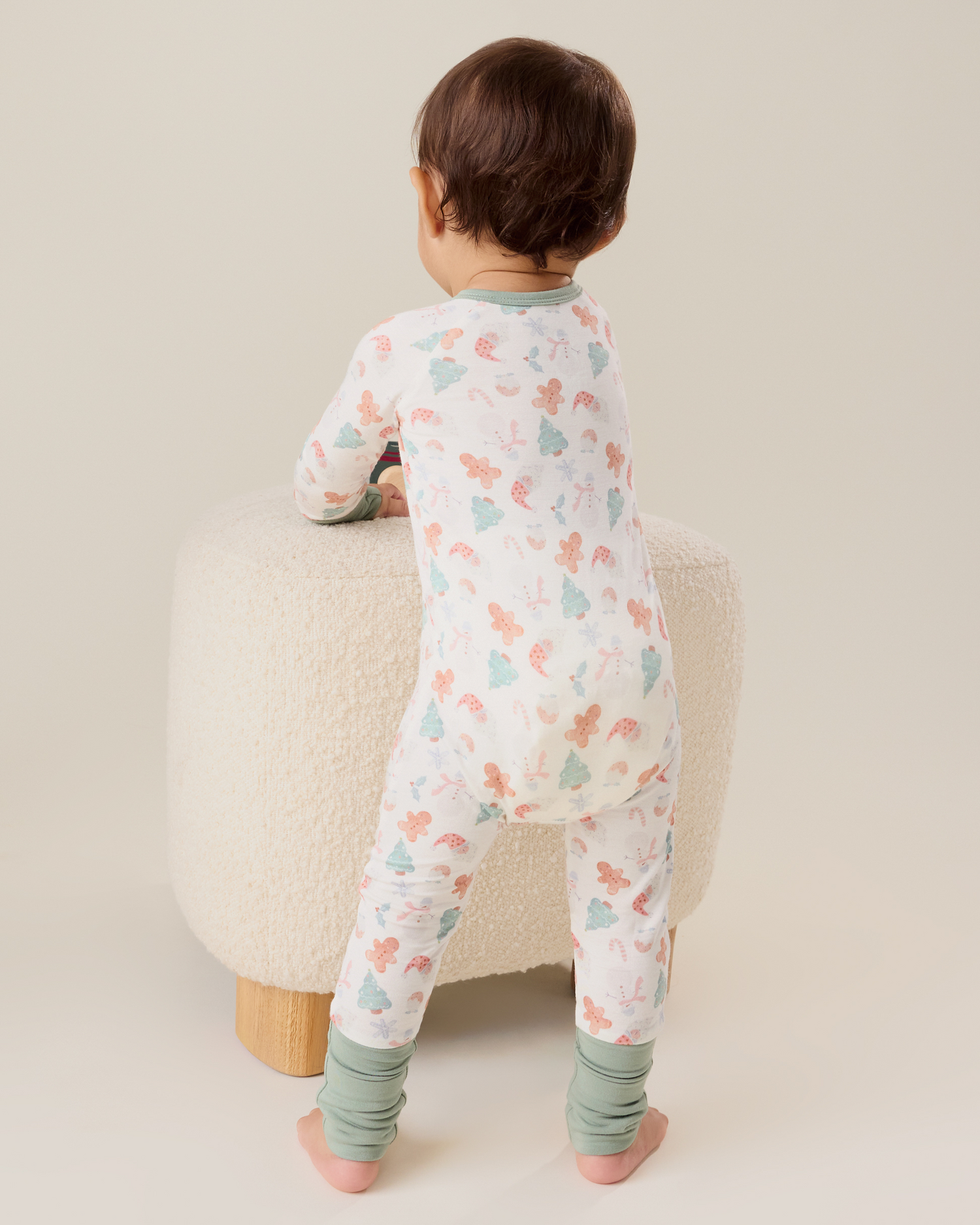 Baby wearing the Bamboo Baby Pajama in Cozy Holiday pattern with soft light green trim