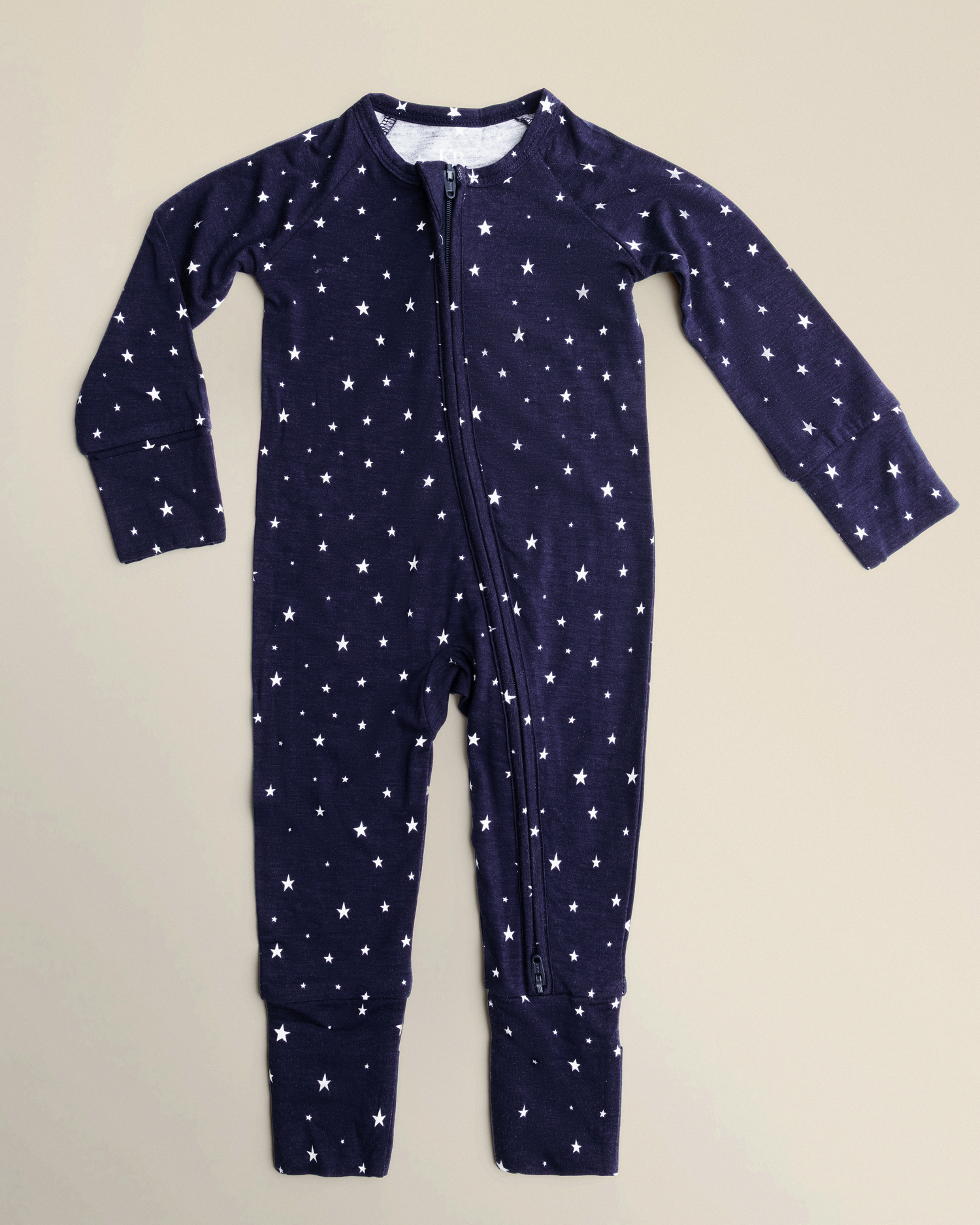 Bamboo Baby Pajamas in Navy Stars on a beige background