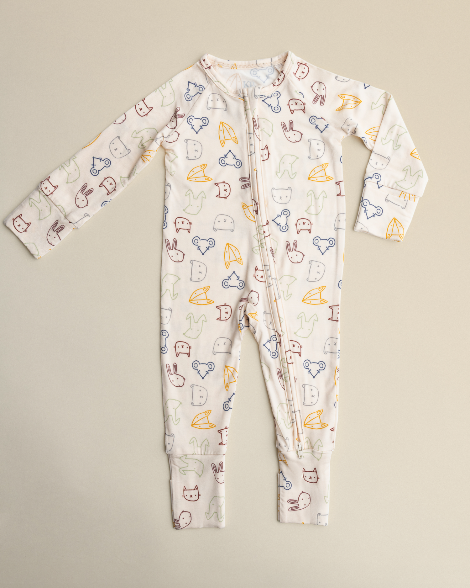 Bamboo Baby Pajamas in Critter Crew on a beige background