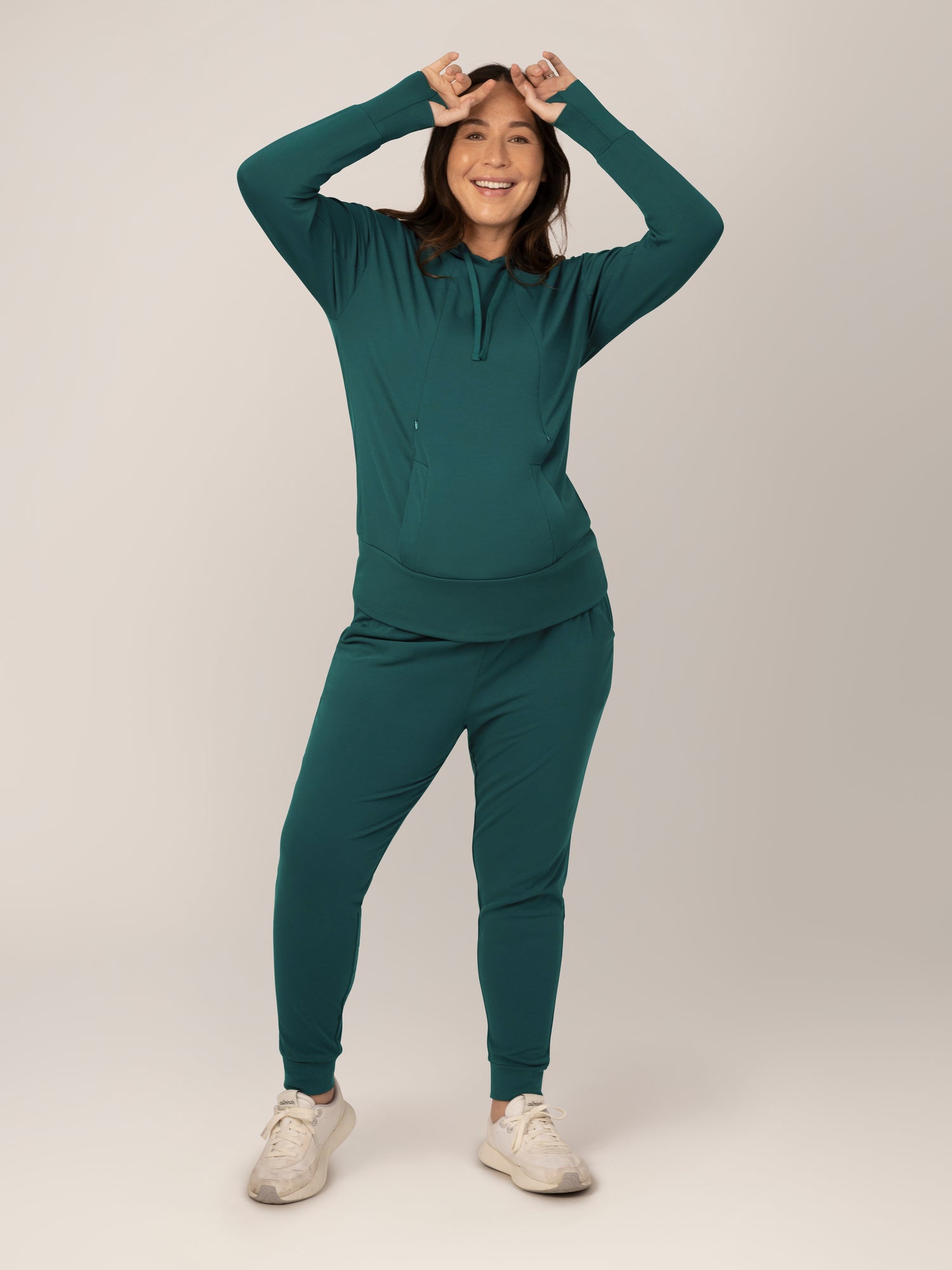 Full body front view of model wearing the Bamboo Maternity & Nursing Hoodie in Evergreen, paired with matching Bamboo Maternity & Postpartum Jogger