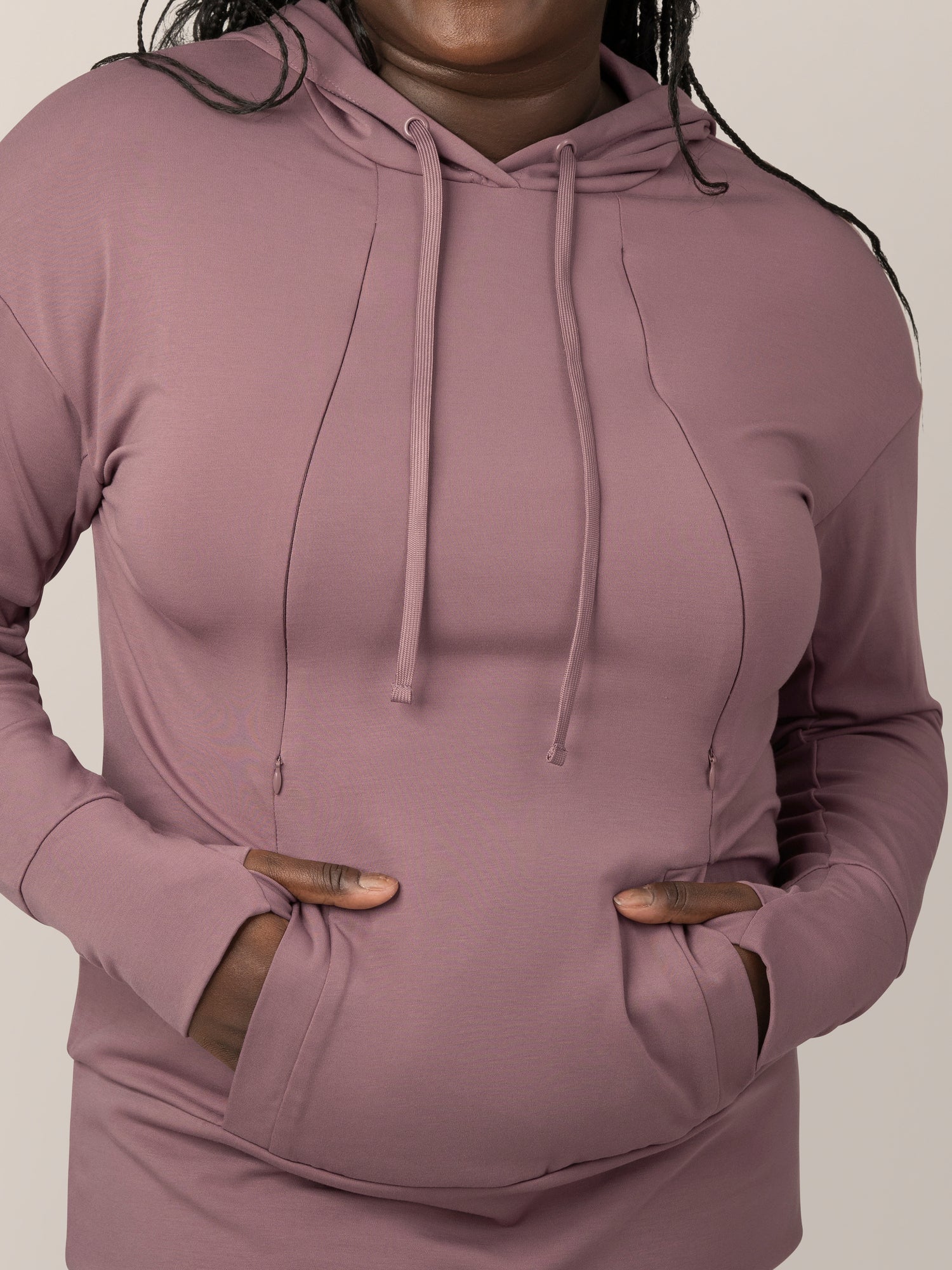Close up view of model wearing the Bamboo Maternity & Nursing Hoodie in Twilight, showing draw strings, zipper nursing access, pocket and thumb holes.