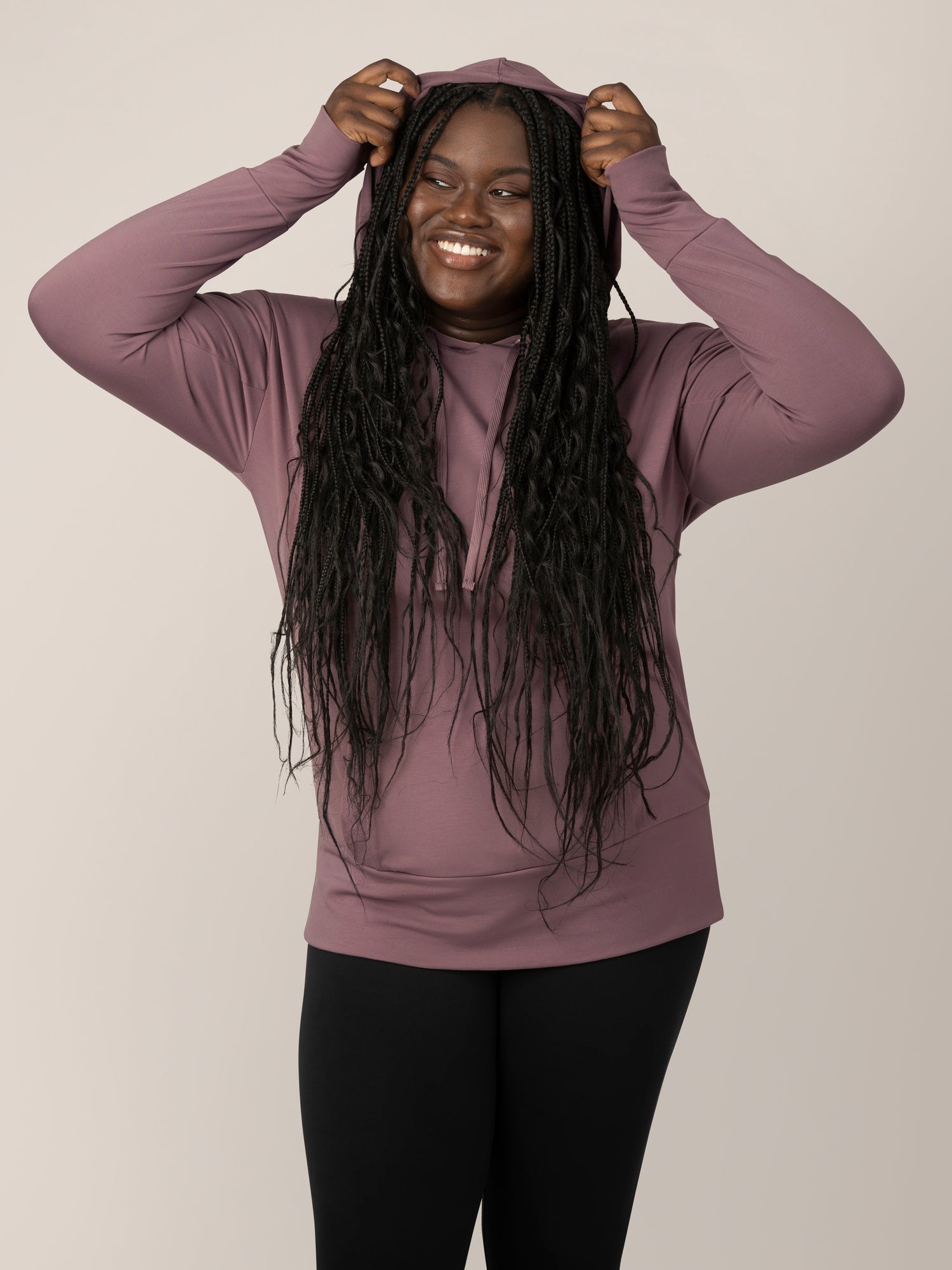Front view of model wearing the Bamboo Maternity & Nursing Hoodie in Twilight, pulling hoodie over head