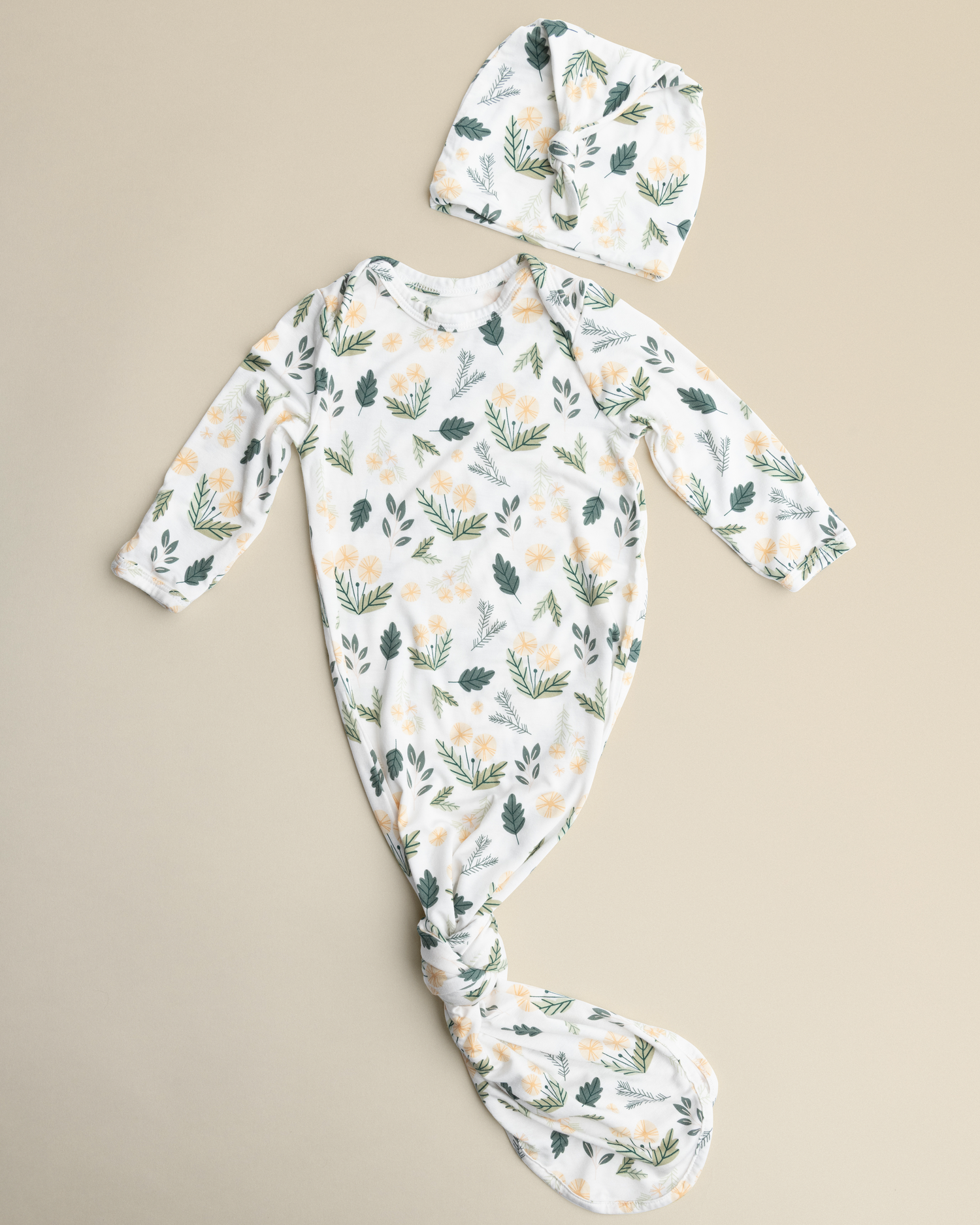 Bamboo Knotted Baby Gown in Honey Dandelion on a beige background