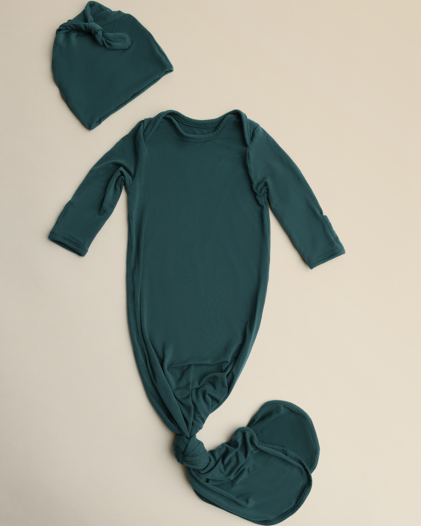 Bamboo Knotted Baby Gown in Evergreen on a beige background