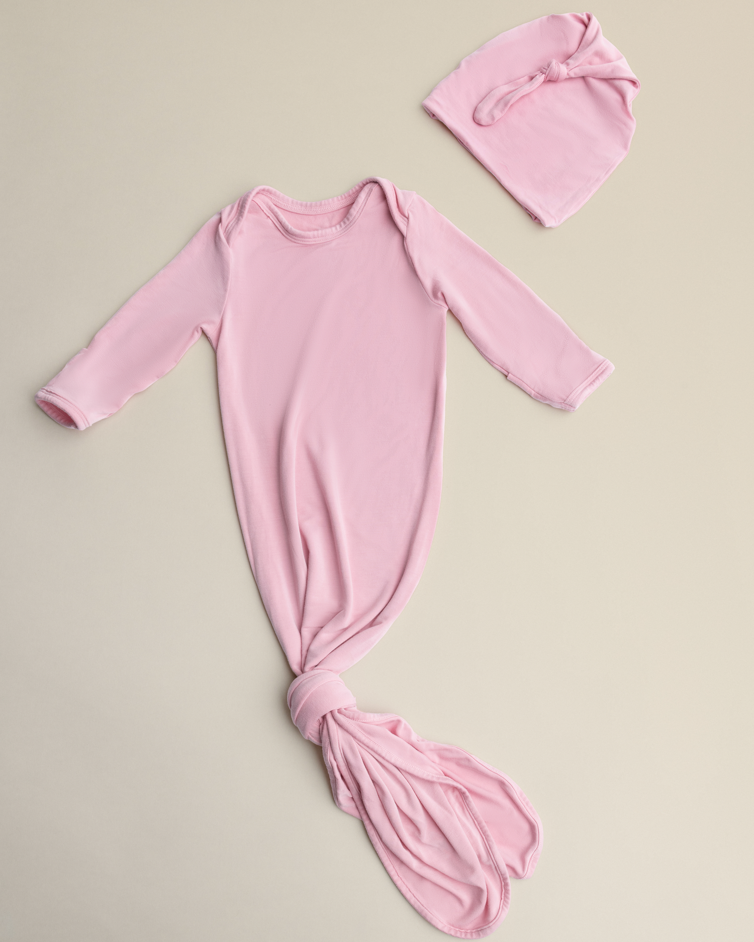 Bamboo Knotted Baby Gown in Light Mauve on a beige background