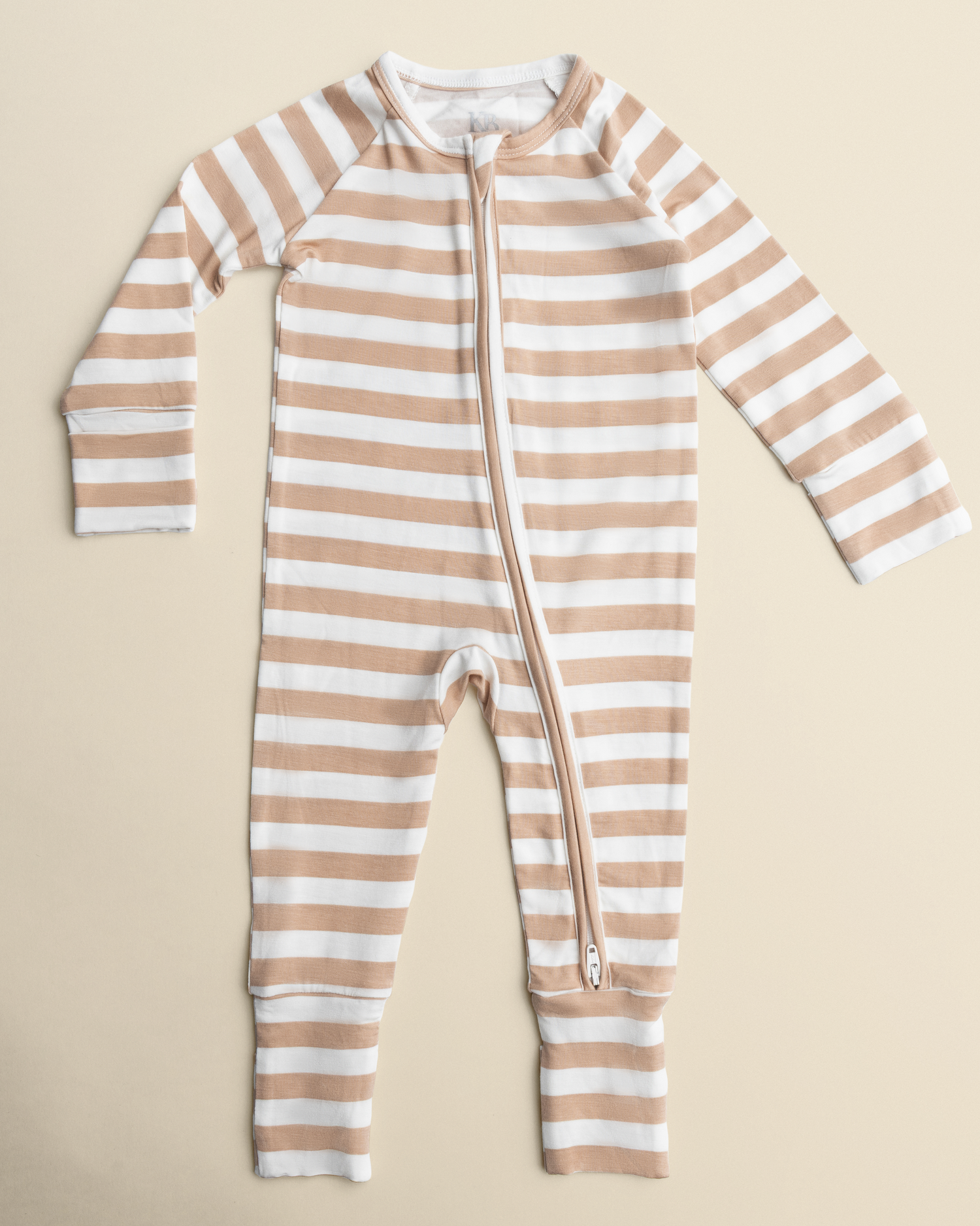 Bamboo Baby Pajamas in Fawn Stripe with a zipper on a beige background