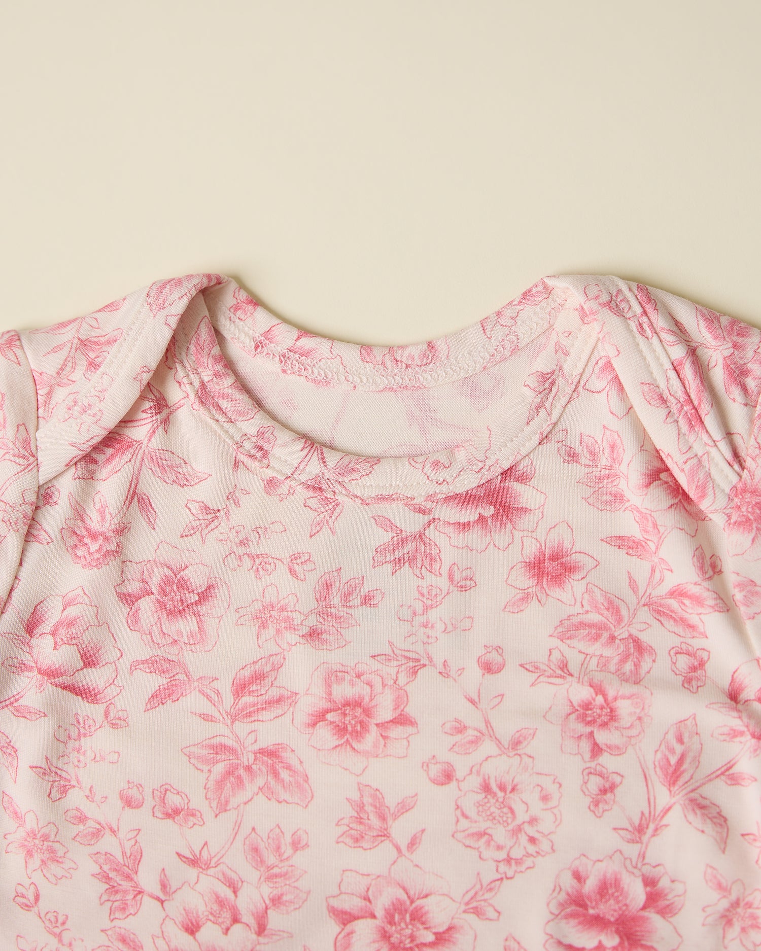 Close-up of Bamboo Knotted Baby Gown & Hat in pink toile