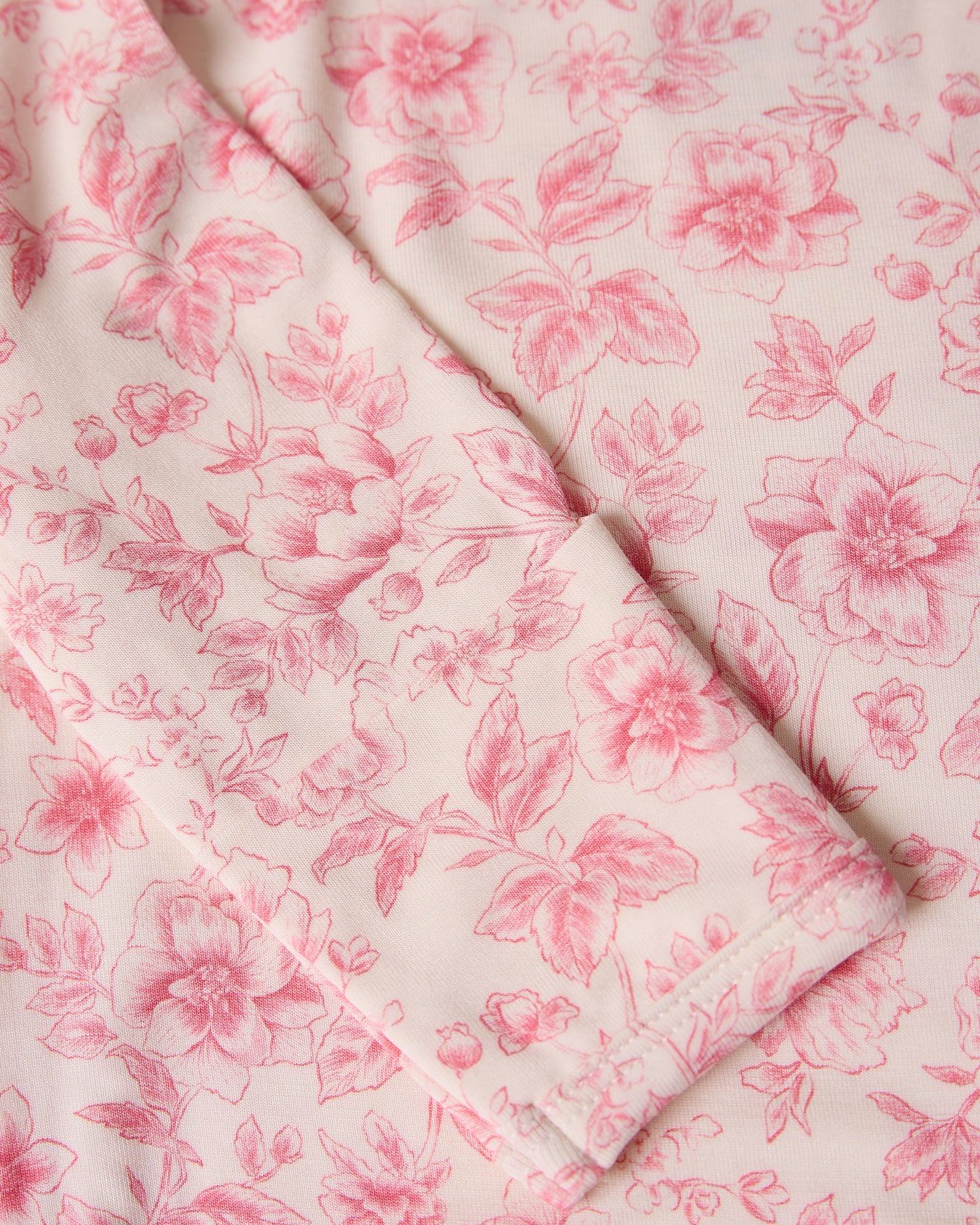 Close-up of Bamboo Knotted Baby Gown & Hat in pink toile with pink flowers