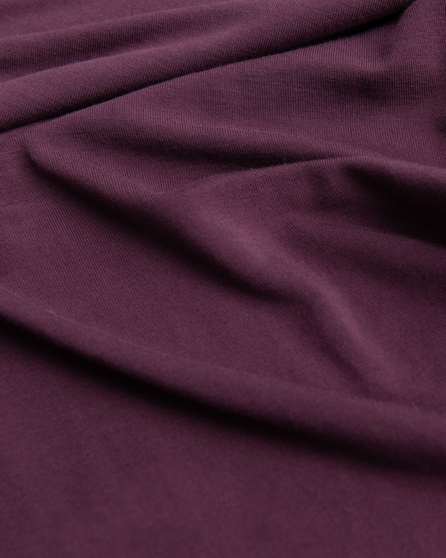 Close-up of wearing Bamboo Baby Pajamas in Burgundy Plum with folds