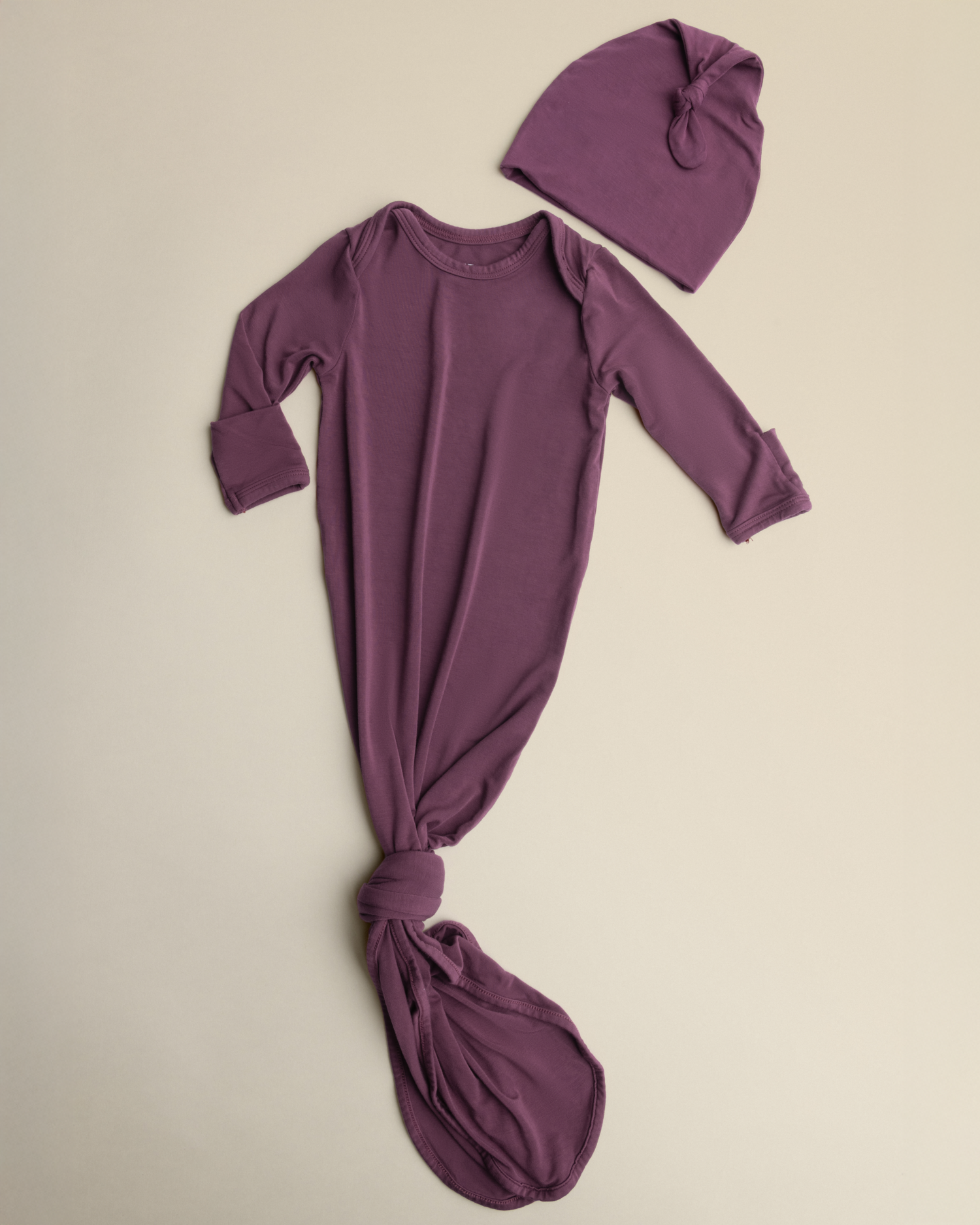 Bamboo Knotted Baby Gown in Burgundy Plum on a beige background