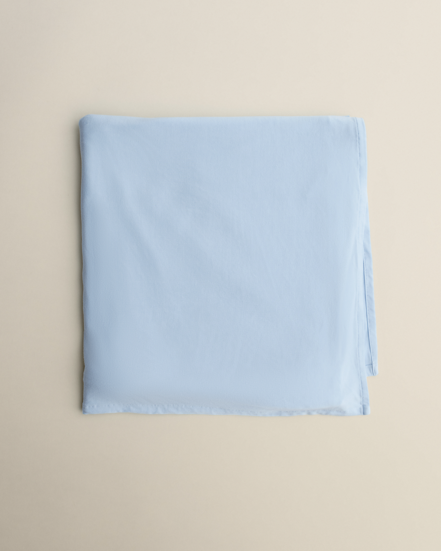 Bamboo Swaddle Blanket in French Blue on a beige background