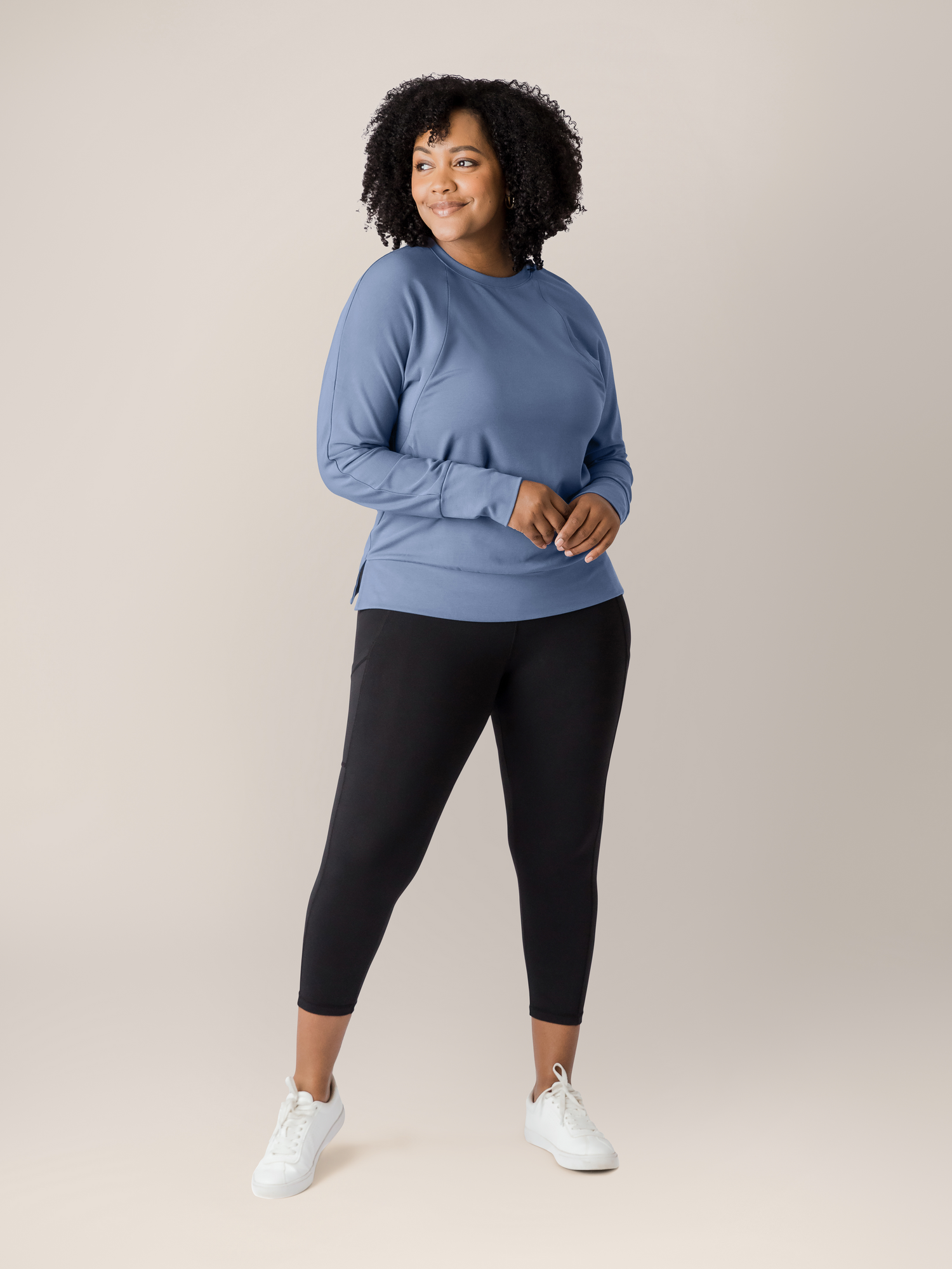 Model wearing the Bamboo Maternity & Nursing Crew Neck Sweatshirt in Slate Blue with her hands at her front. @model_info:Roxanne is wearing a Large.