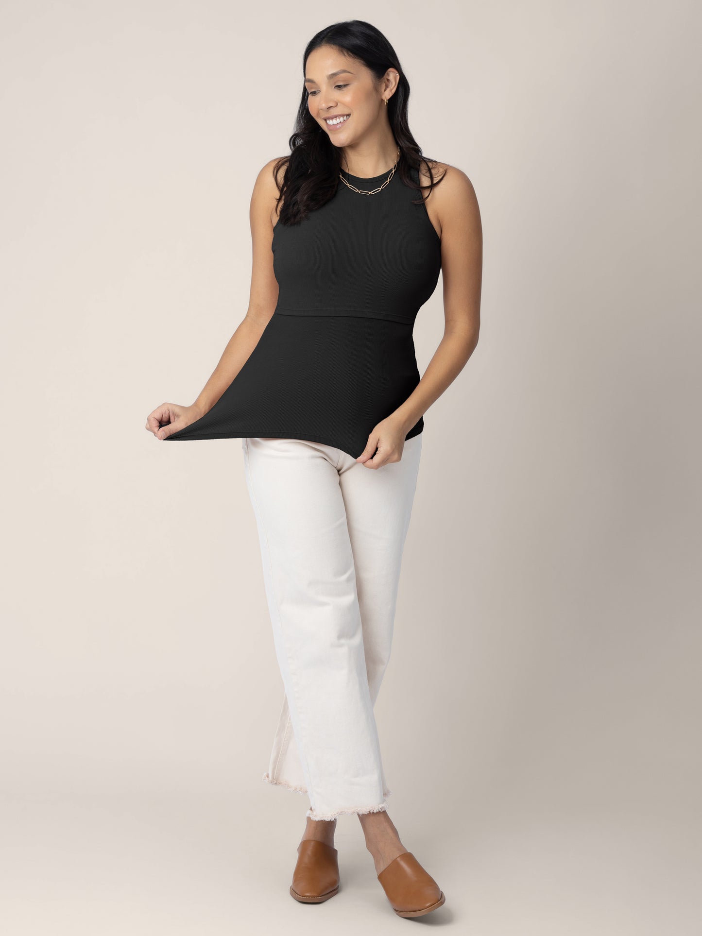 Model wearing the Ribbed Bamboo Racerback Nursing Tank in black, paired with cropped pants and shoes
