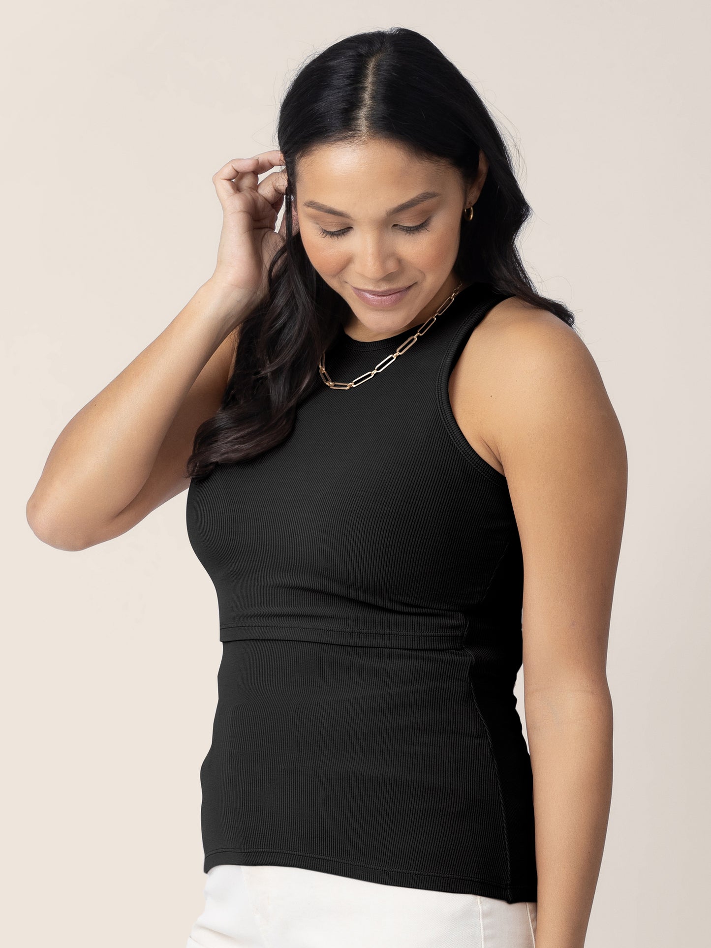 3/4 angle view of model wearing the Ribbed Bamboo Racerback Nursing Tank in black