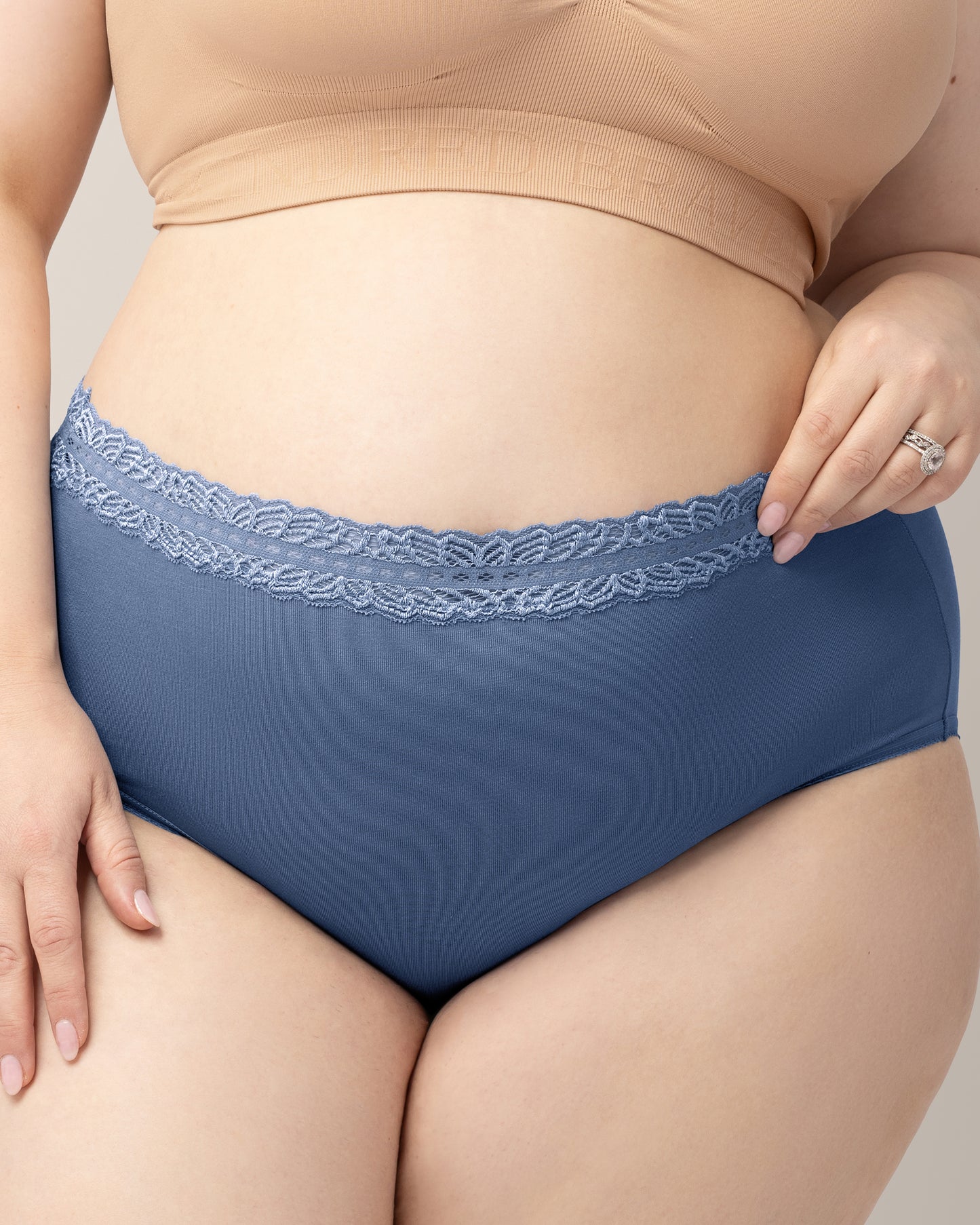 Person wearing blue underwear with lace trim on a neutral background@model_info:Rachel is wearing an X-Large.