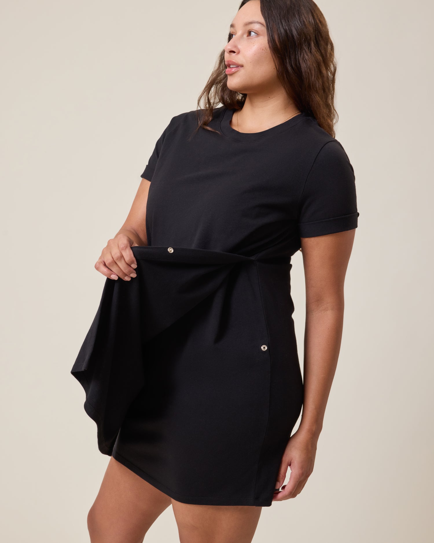 Woman wearing the Classic Nursing T-shirt Mini Dress in black, showing nursing access with a plain background
