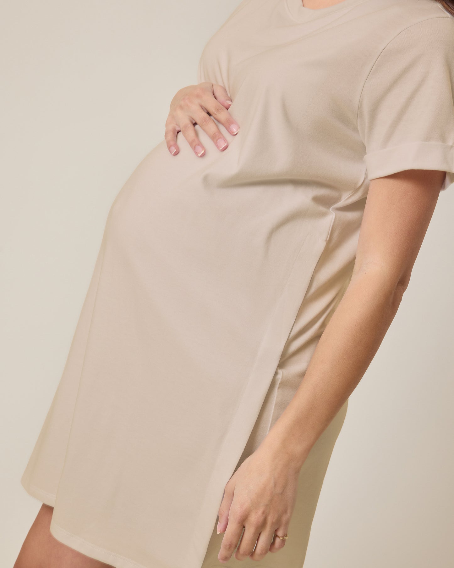 Pregnant woman wearing the Classic Nursing T-shirt Mini Dress in Sand