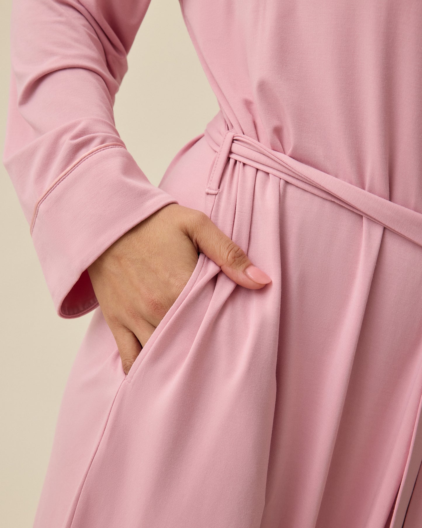 Close up of pocket on Clea Bamboo Robe in Light Mauve on a beige background