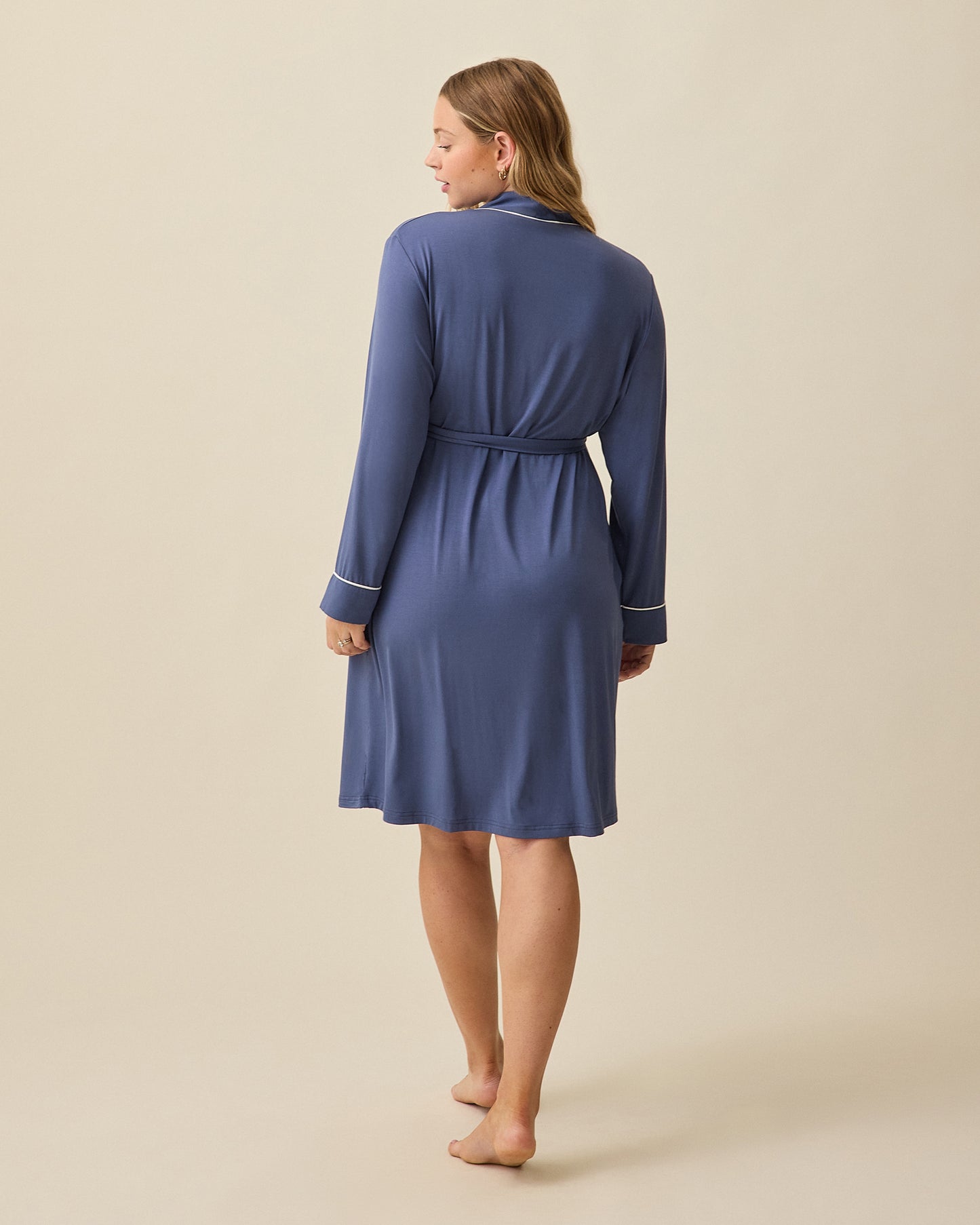 Model displaying back view of Clea Bamboo Robe in Slate Blue on beige background